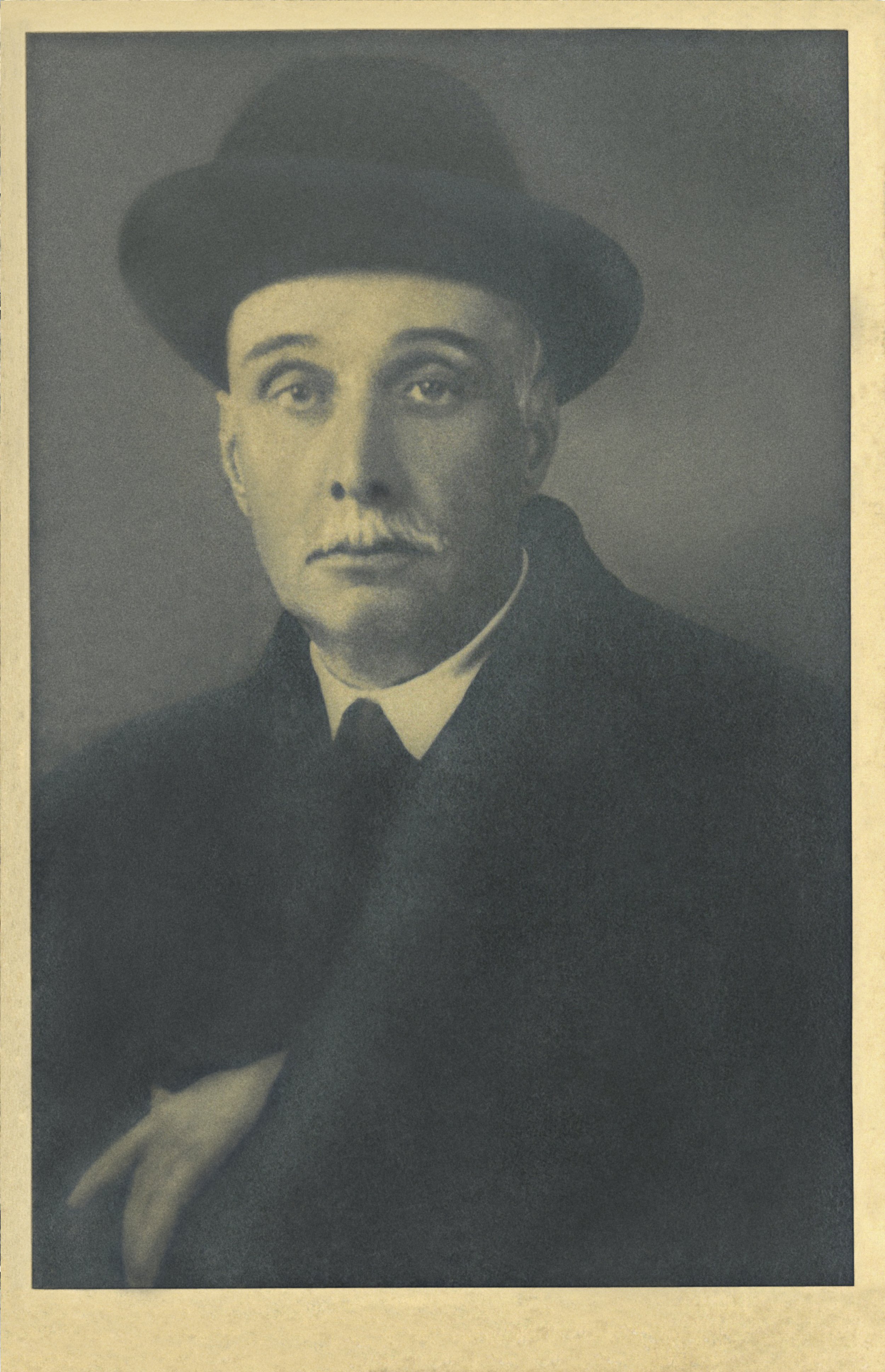 Sepia-toned portrait of an older man wearing a bowler hat and suit