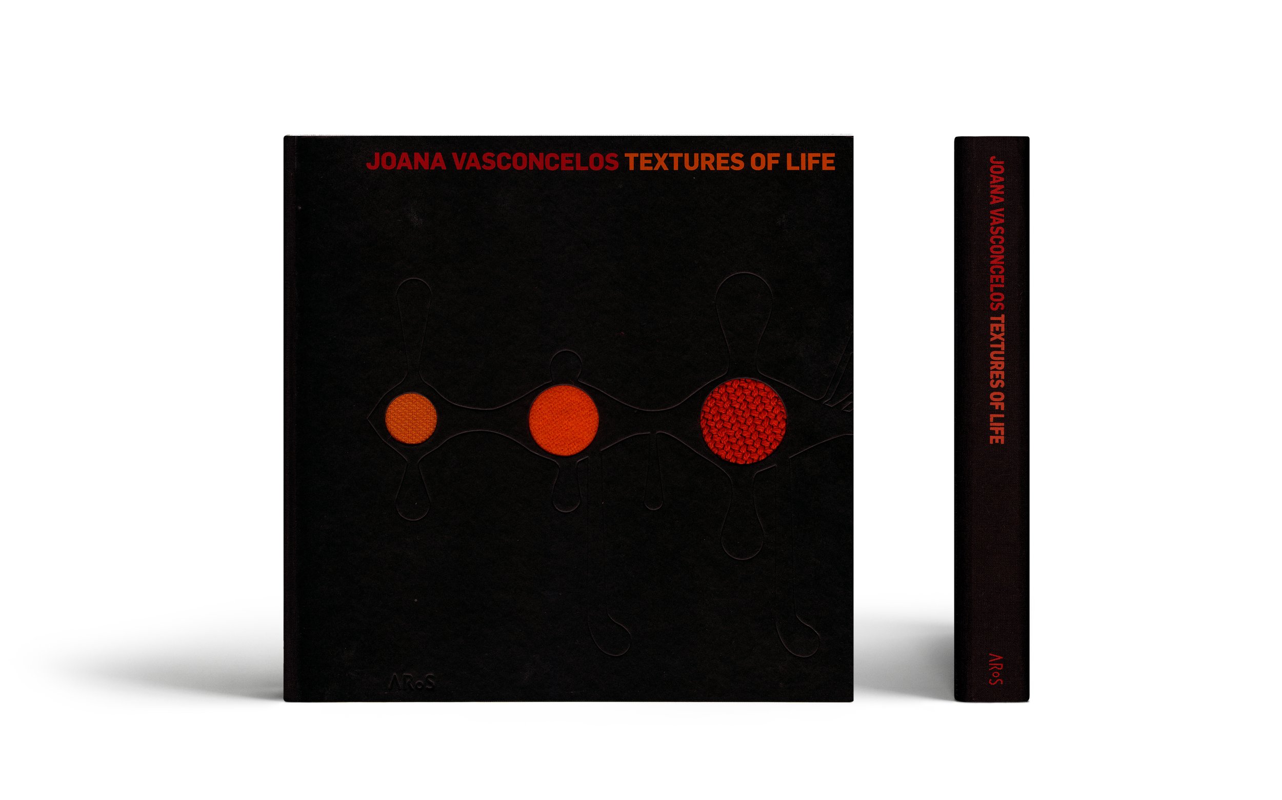Cover and spine of the book "Joana Vasconcelos: Textures of Life" with abstract design in red on a black background.