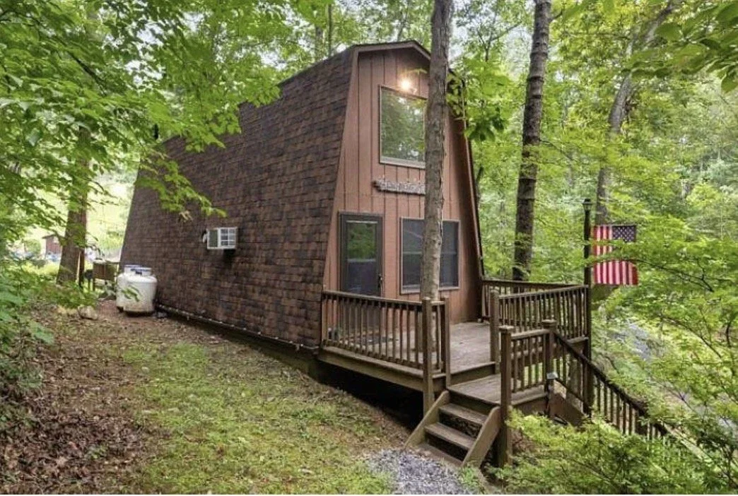 Photo - Cozy cabin in the woods, surrounding by lush canopy of forest. Cabin located at 21 Creekwood Ln in Lyndhurst, VA. 