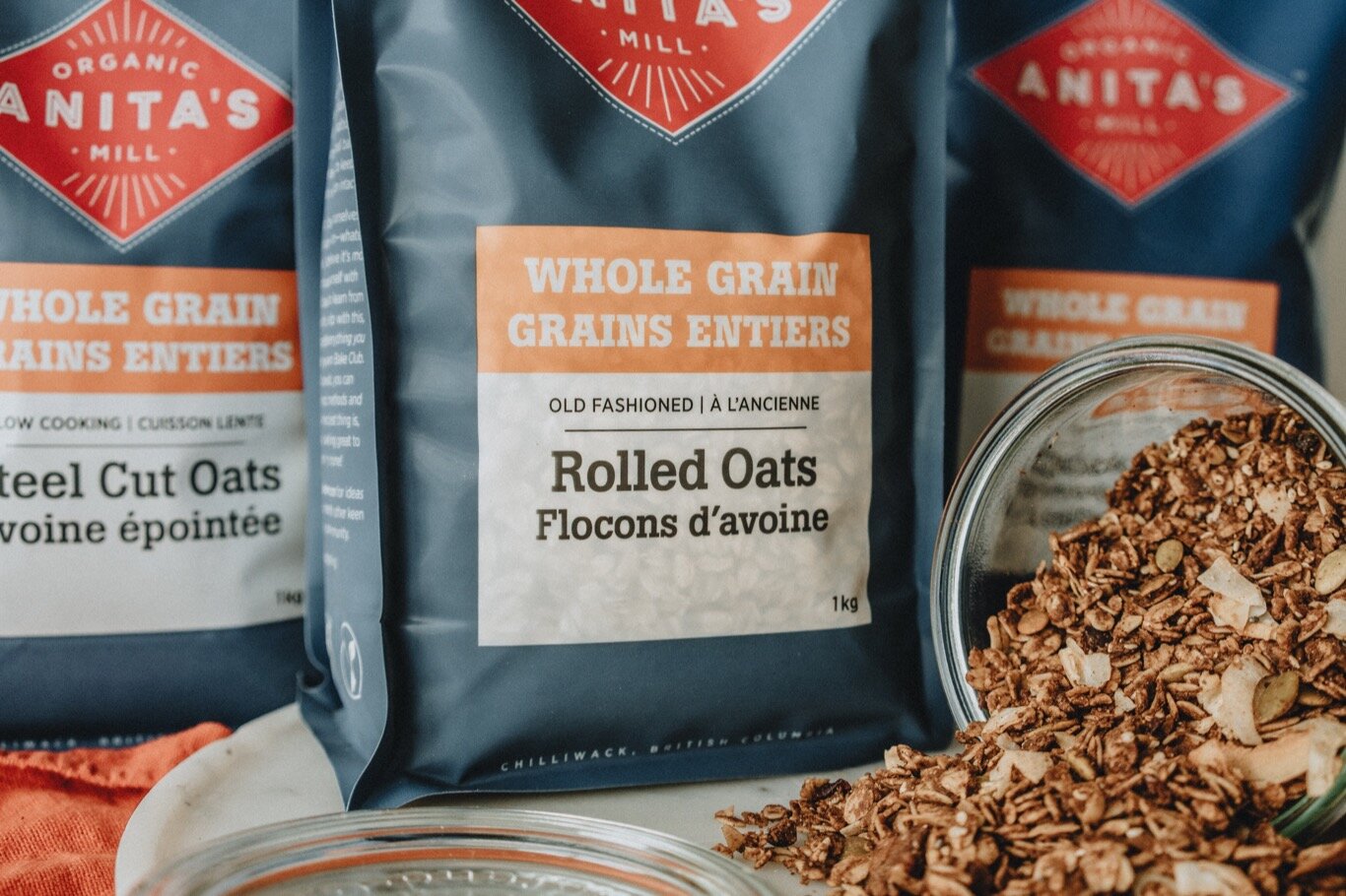 Anitas-Organic-Mill-Product-2020-whole-grain-rolled-oats-with-granola-pouring-out-web.jpg
