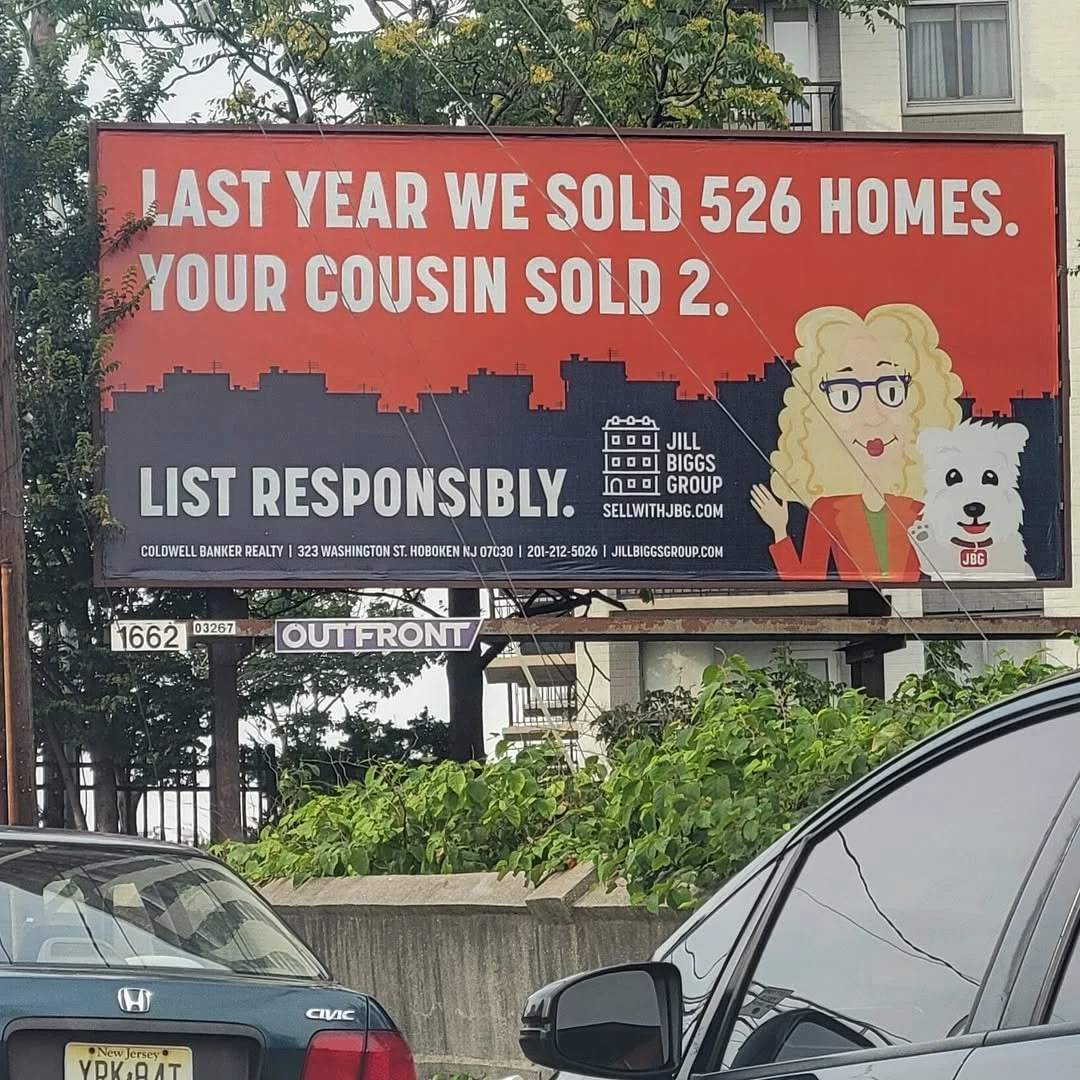 The Jill Biggs Group billboard in Jersey City, NJ: Last Year We Sold 526 Homes. Your Cousin Sold 2.