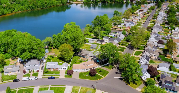 Aerial view of tree-lined residential streets and a lake in Tenafly, New Jersey