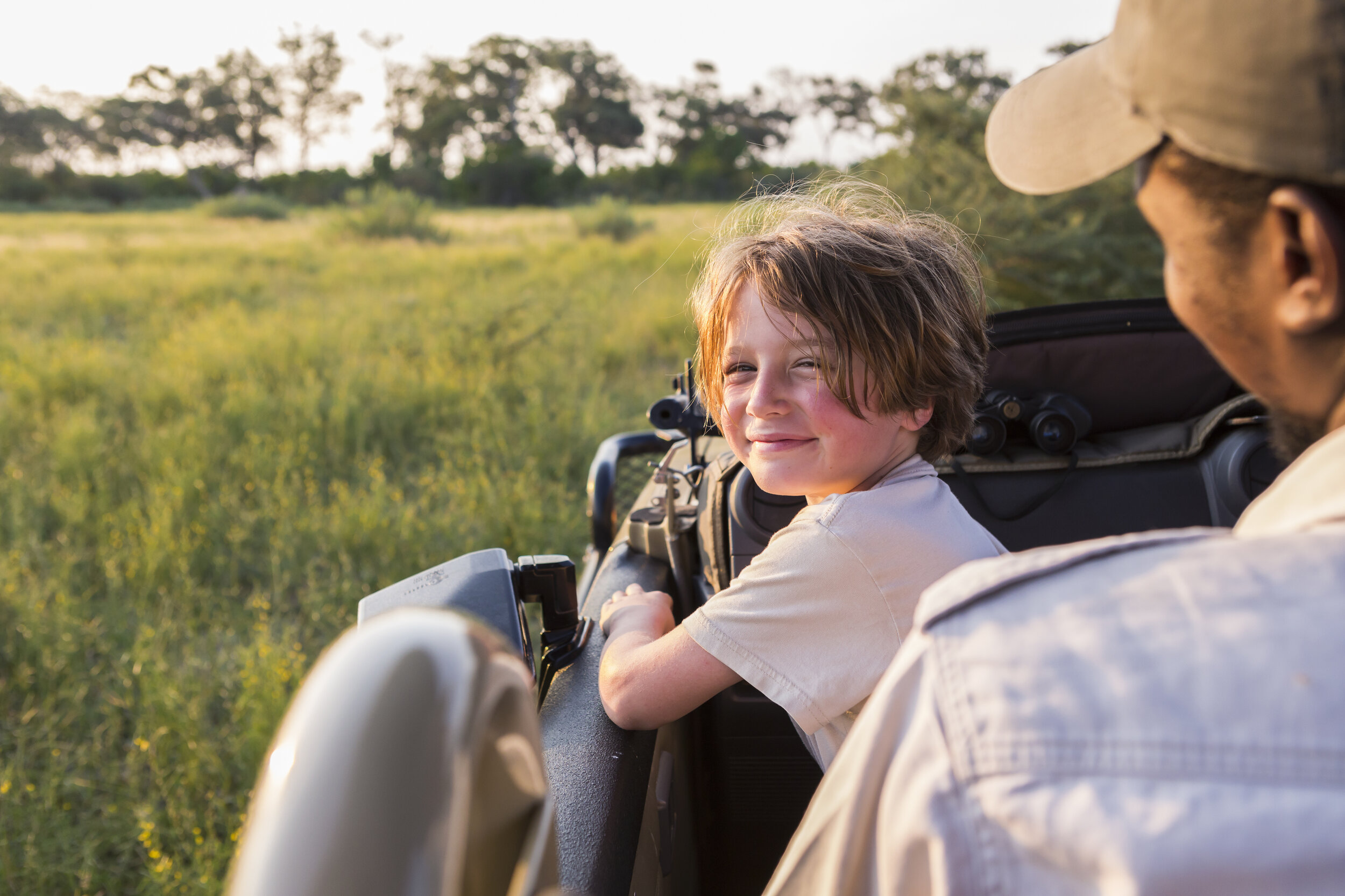 smiling-6-year-old-boy-steering-safari-vehicle-bot-VYNMRGY.jpg