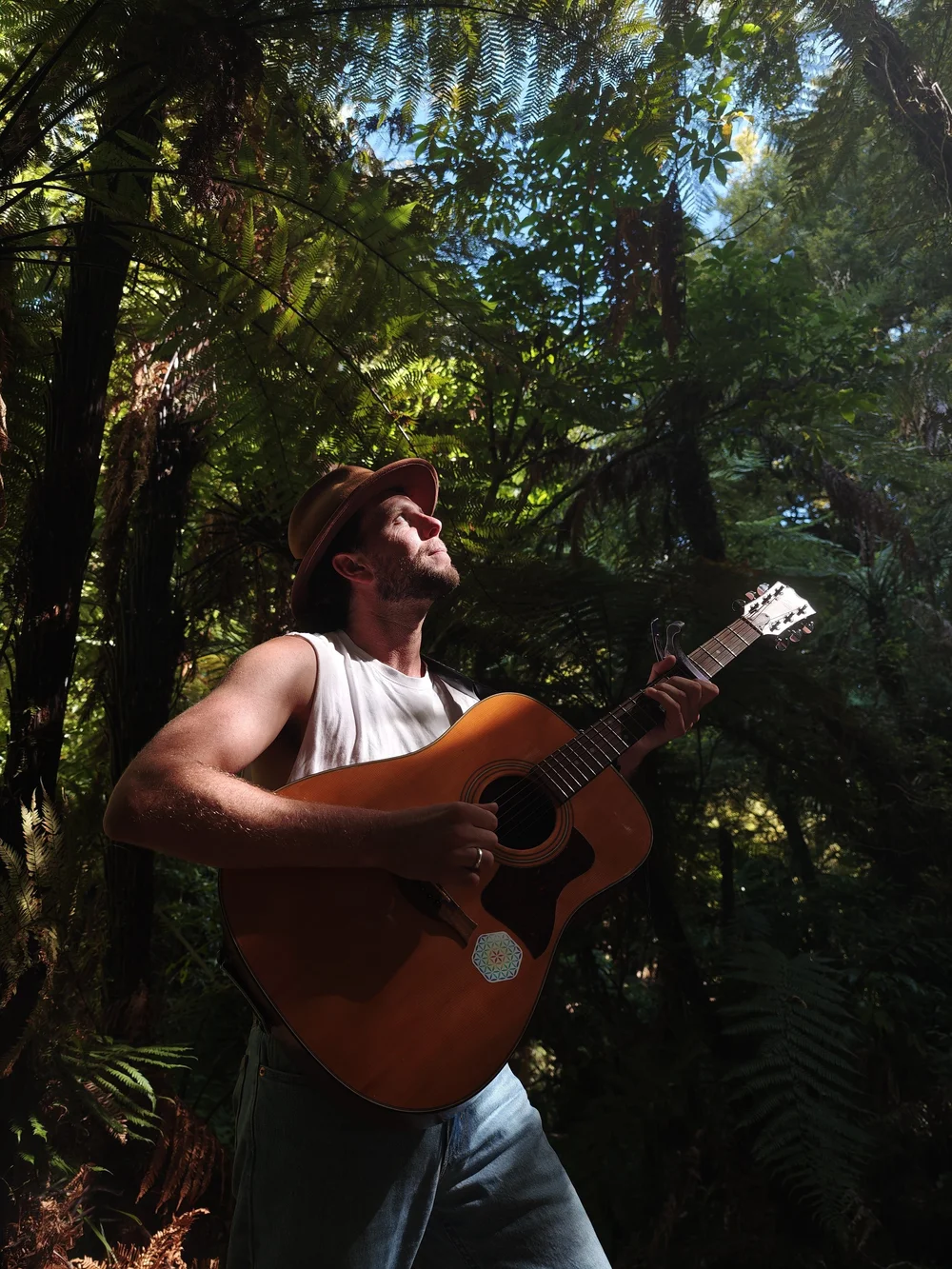 Jamen Moss playing guitar in the forest