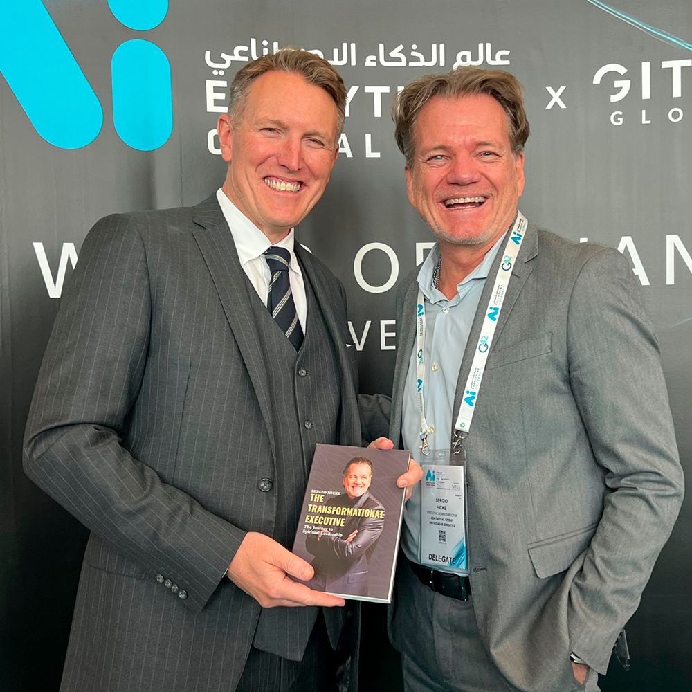 A house on a hill with mountains in the background, snow-capped peaks under a cloudy sky.