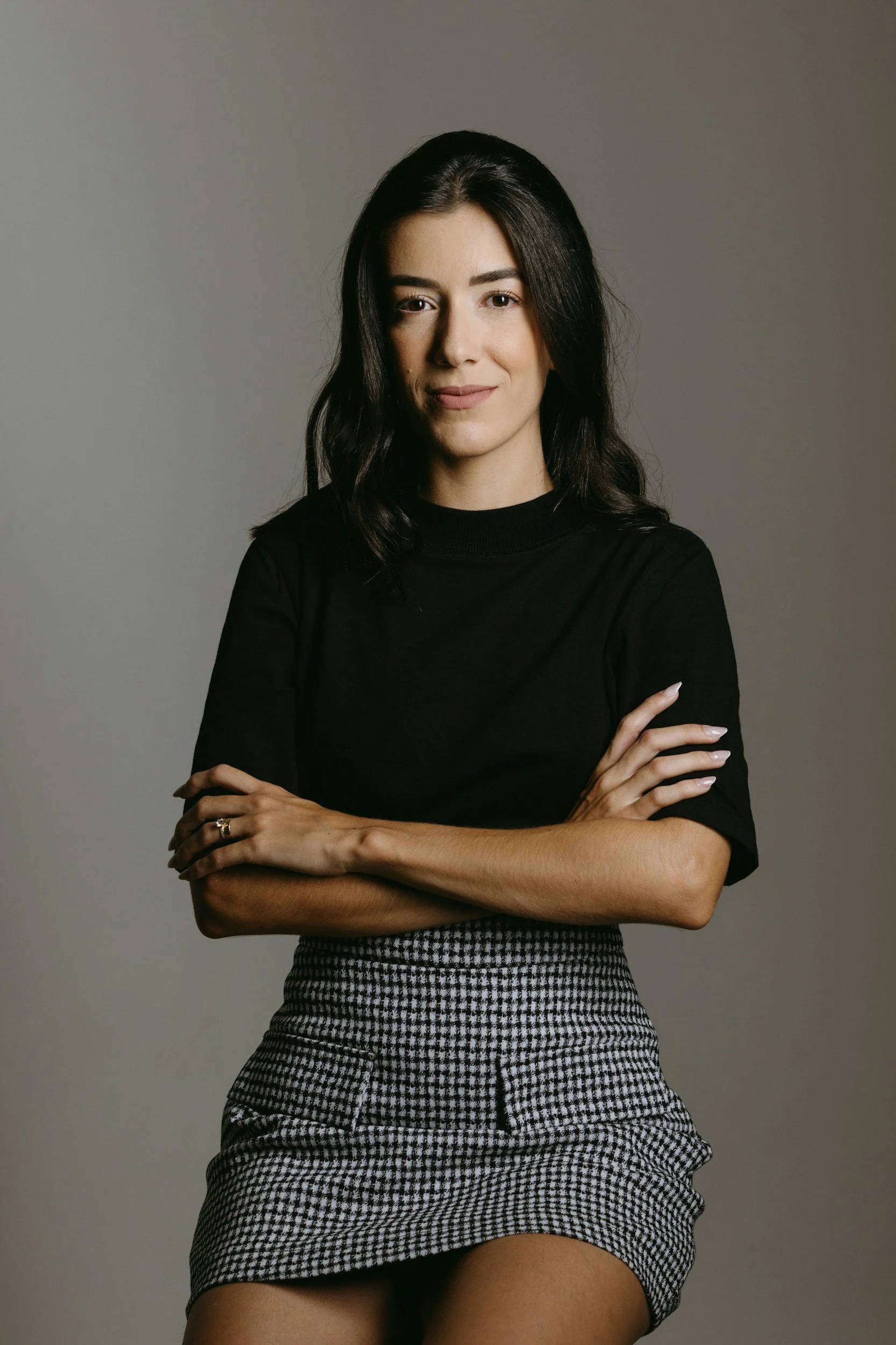Confident woman leader standing with arms crossed, representing authority and clarity