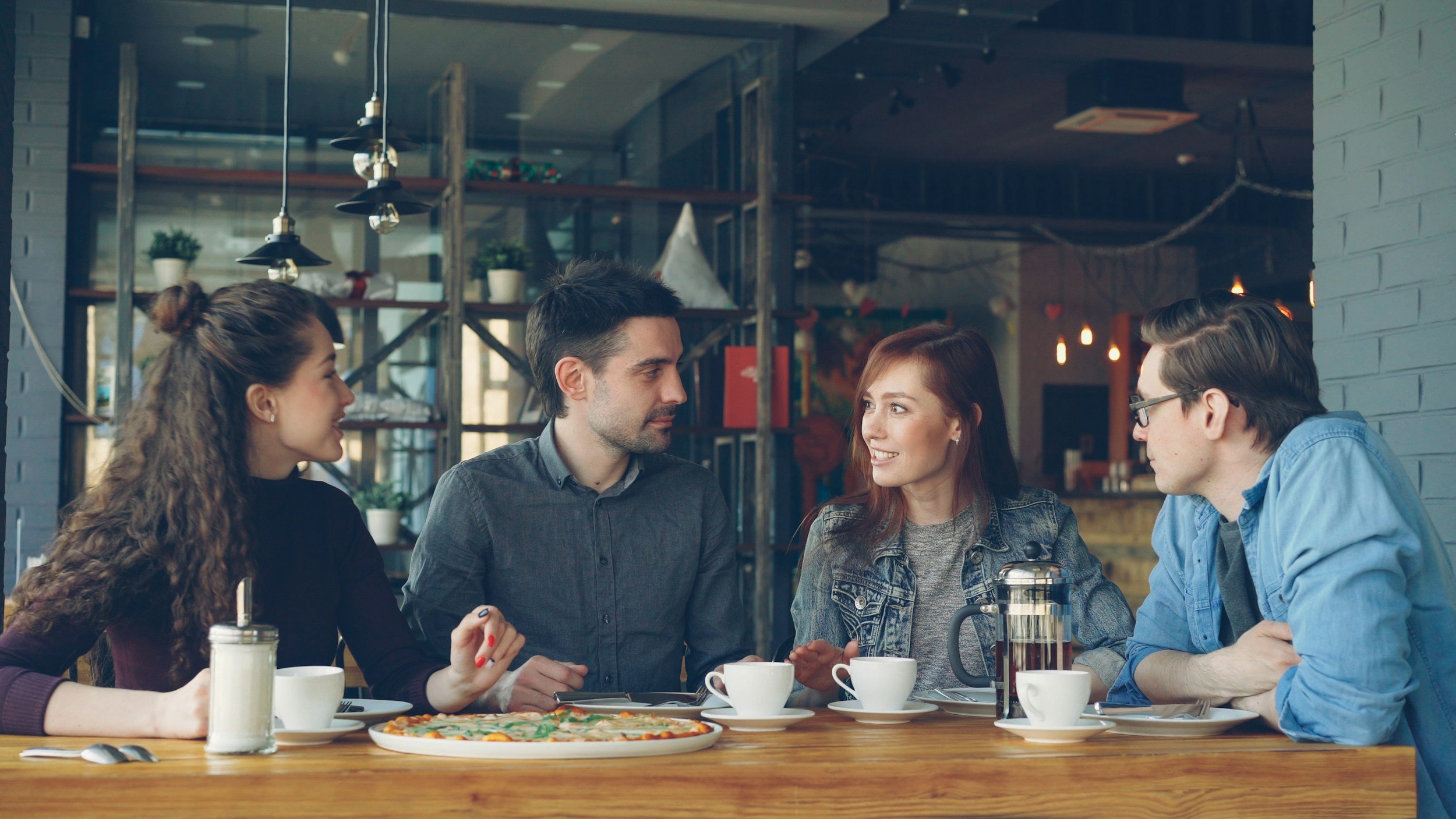 Professionals engaged in a focused leadership conversation in an informal setting