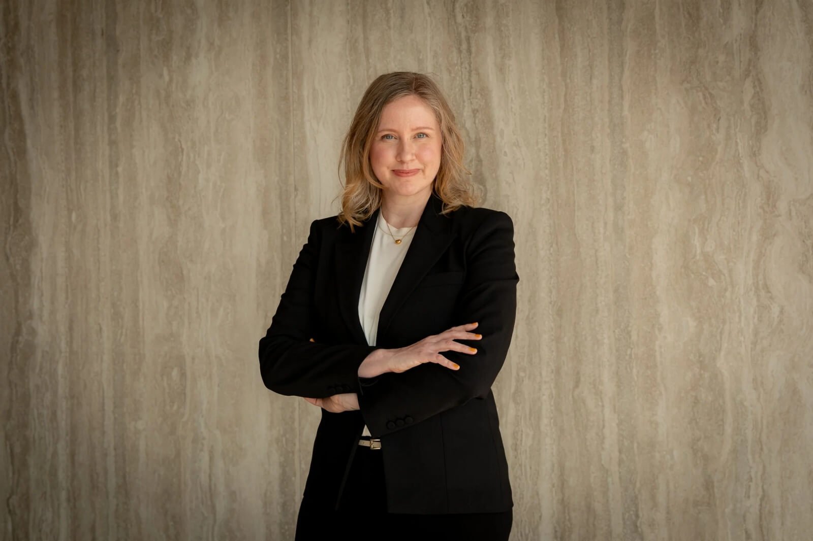 Heather Dobbin, executive coach and leadership advisor, standing confidently in a professional portrait