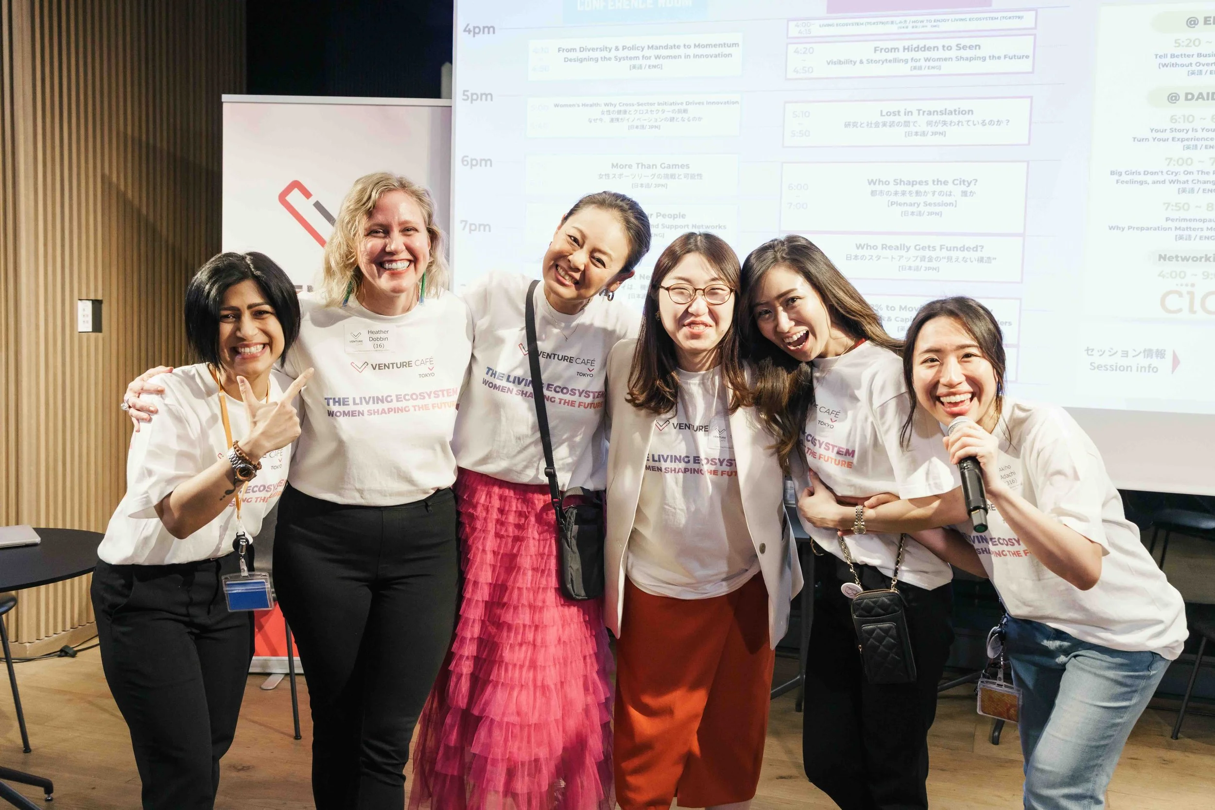 a group of women organizers pose for a group ohoto