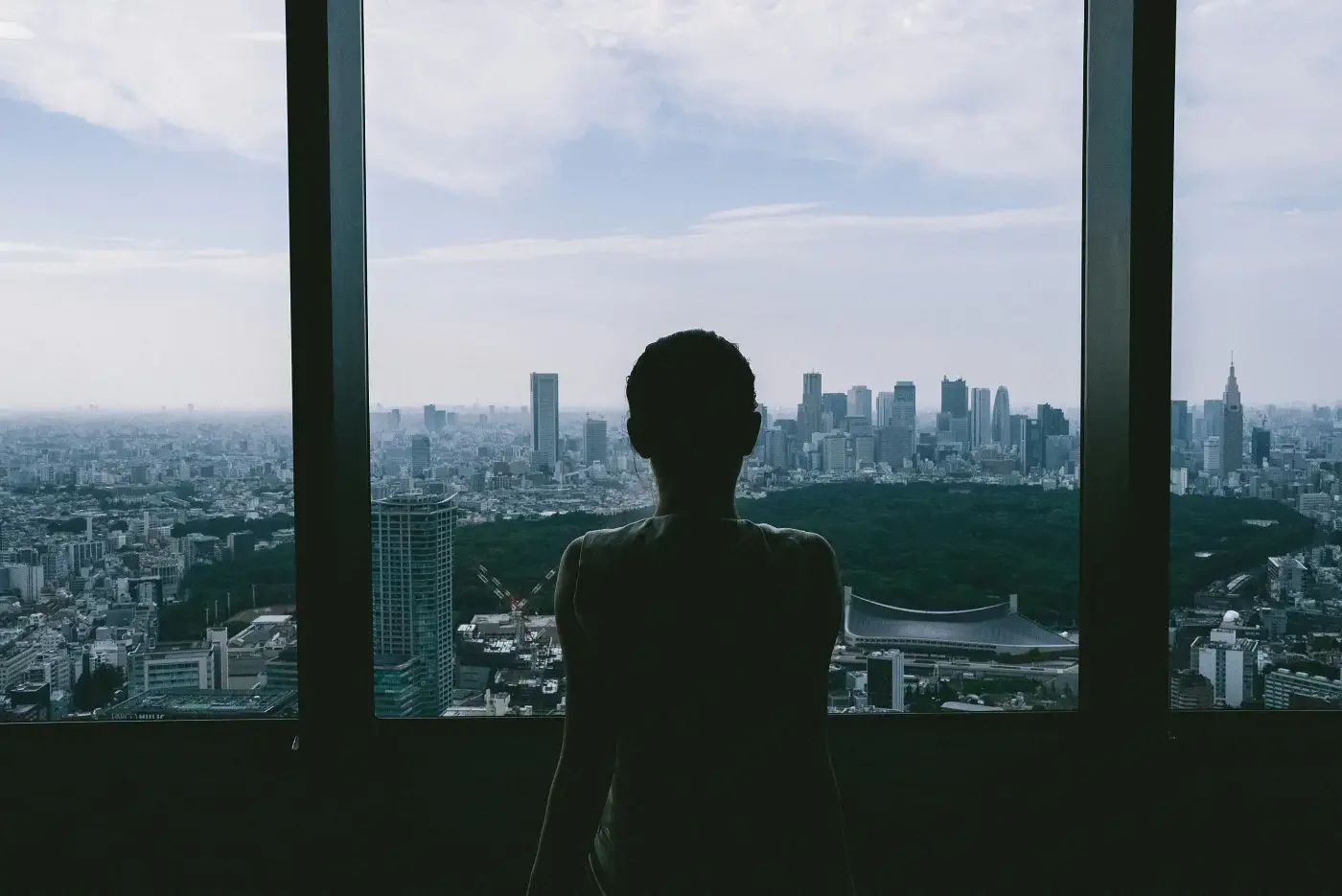 Founder in Tokyo looking out over the city, reflecting on healthy founder support, community accountability, and burnout prevention