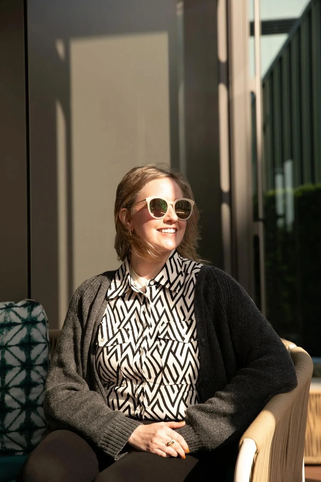 Heather Dobbin at Moshimo in Hayama, relaxing in sunlight with sunglasses during a community gathering day