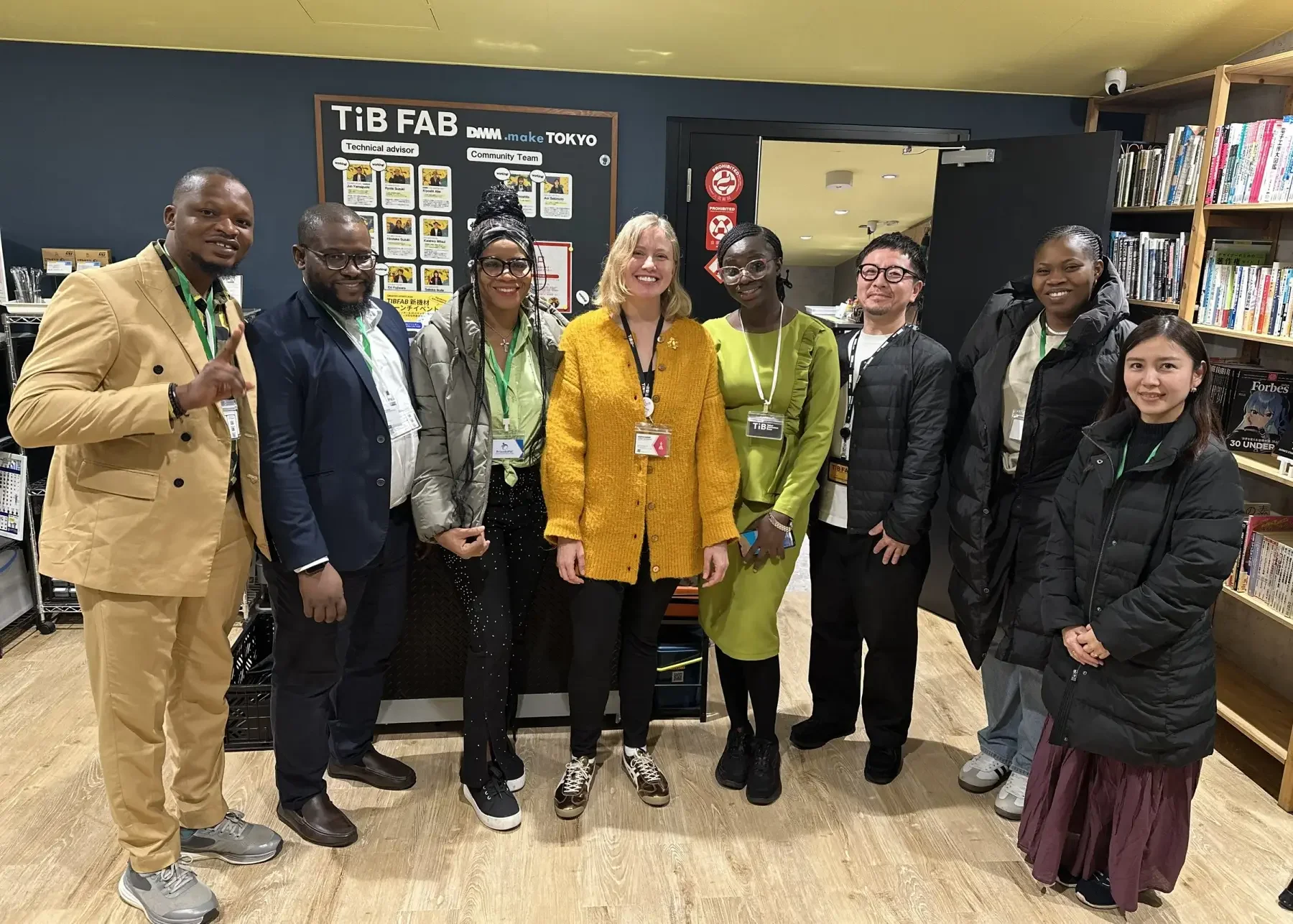 Heather Dobbin standing with diverse entrepreneurs at Tokyo Innovation Base community space in Tokyo, celebrating collaboration and startup ecosystem building