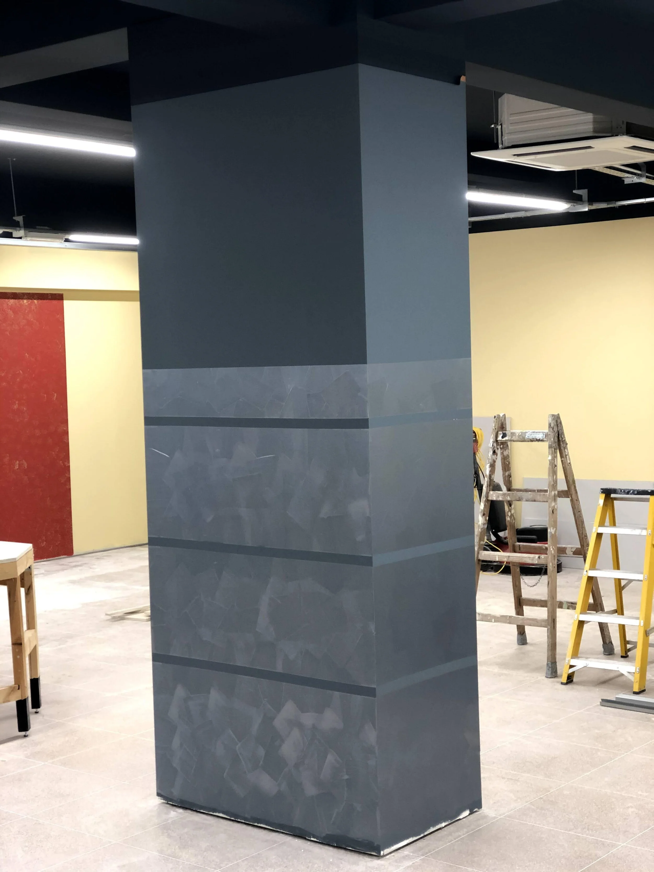 The surface of the centre shop wall finished by custom Italian Oikos Multidecor Spatullata Technique© which will resist any rubbing or unintentional damages after long usage and exposure over time