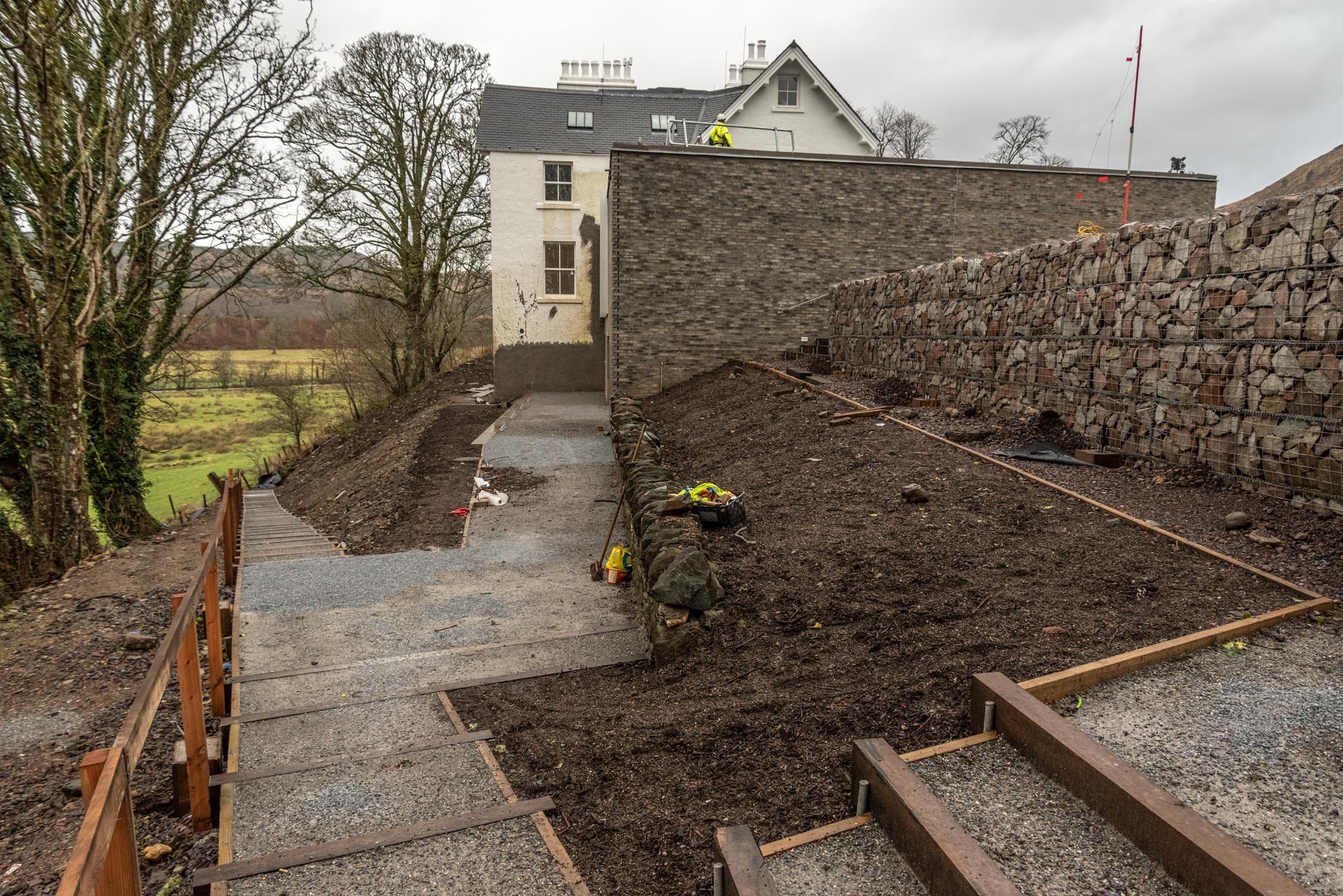  Pathways are being constructed around the redeveloped buildings, providing access to the Glebe field below. 