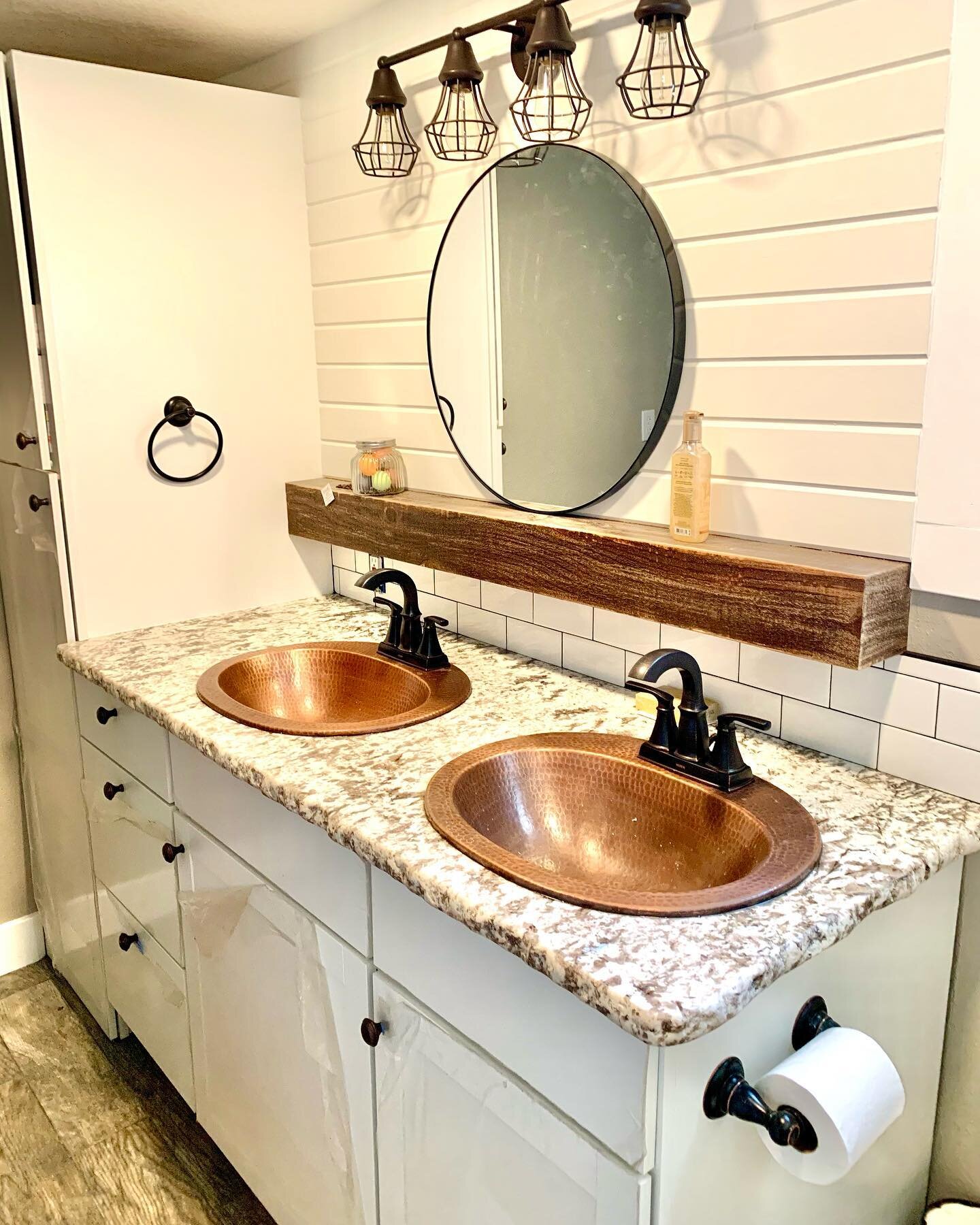A little throw back to another fun bathroom we completed with copper basin sinks and floating wood shelving.

#websterconstruction #bathroomremodel #idahoremodel #copper #homereno #idahome