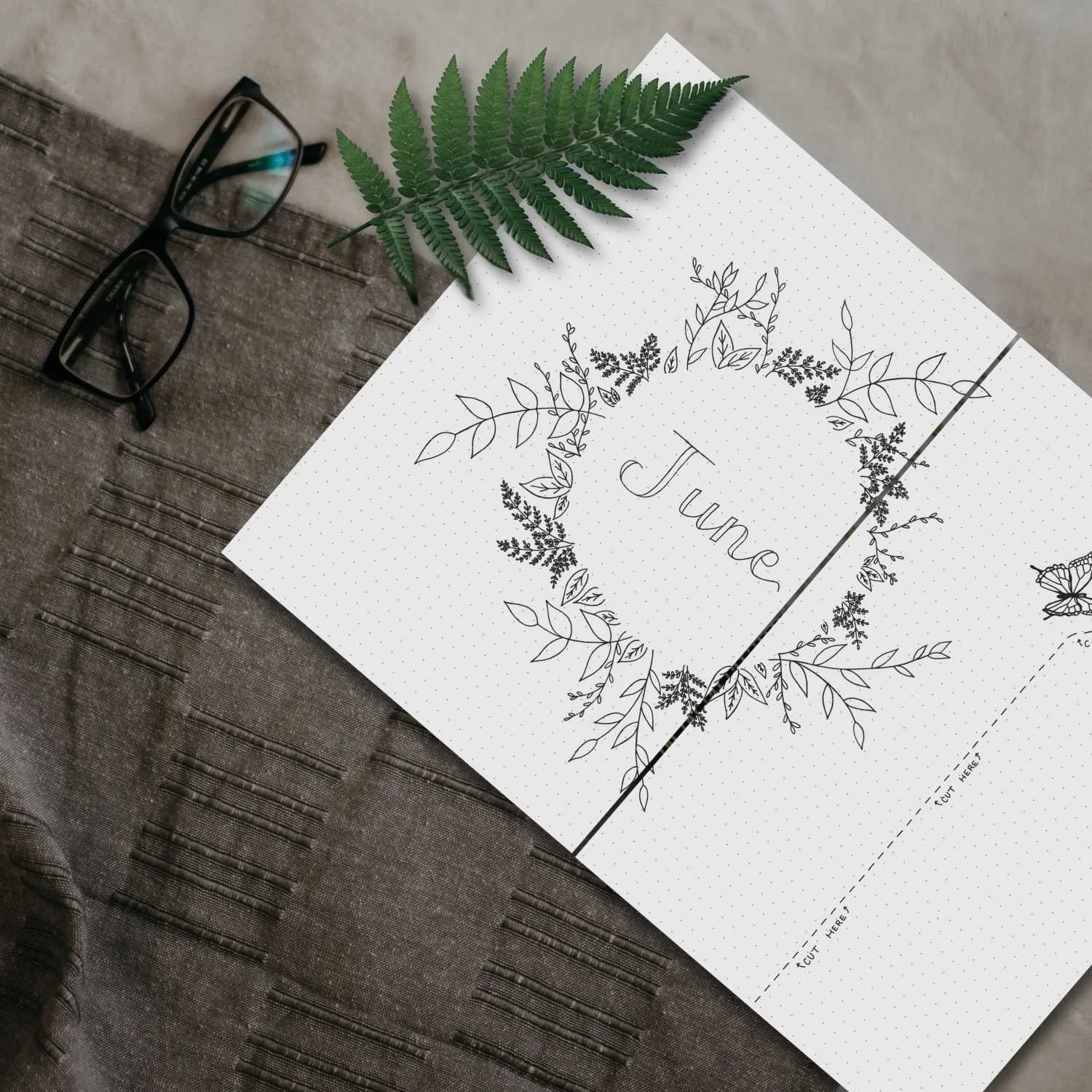 Close-up of a printable planner page with hand-drawn fern illustration and monthly layout from the Intentional Life Planner PDF