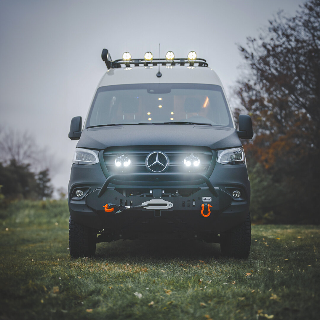 Embrace the spirit of off-grid adventure! This van is perfectly fit for exploration, featuring a CA Tuned front bumper with a winch, d-rings, and white mounted LED lights.