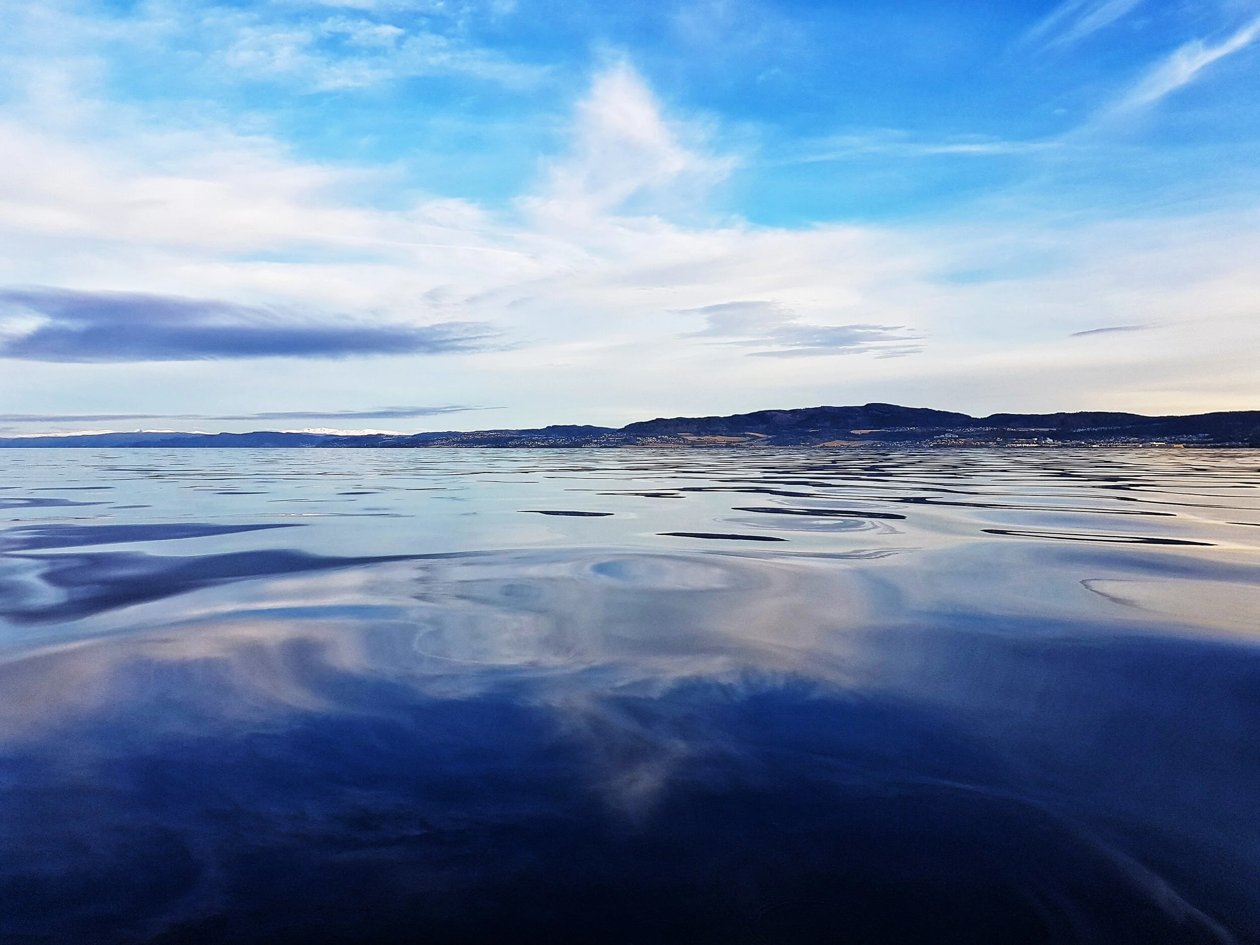 reflections fjord bluesky clouds.jpeg