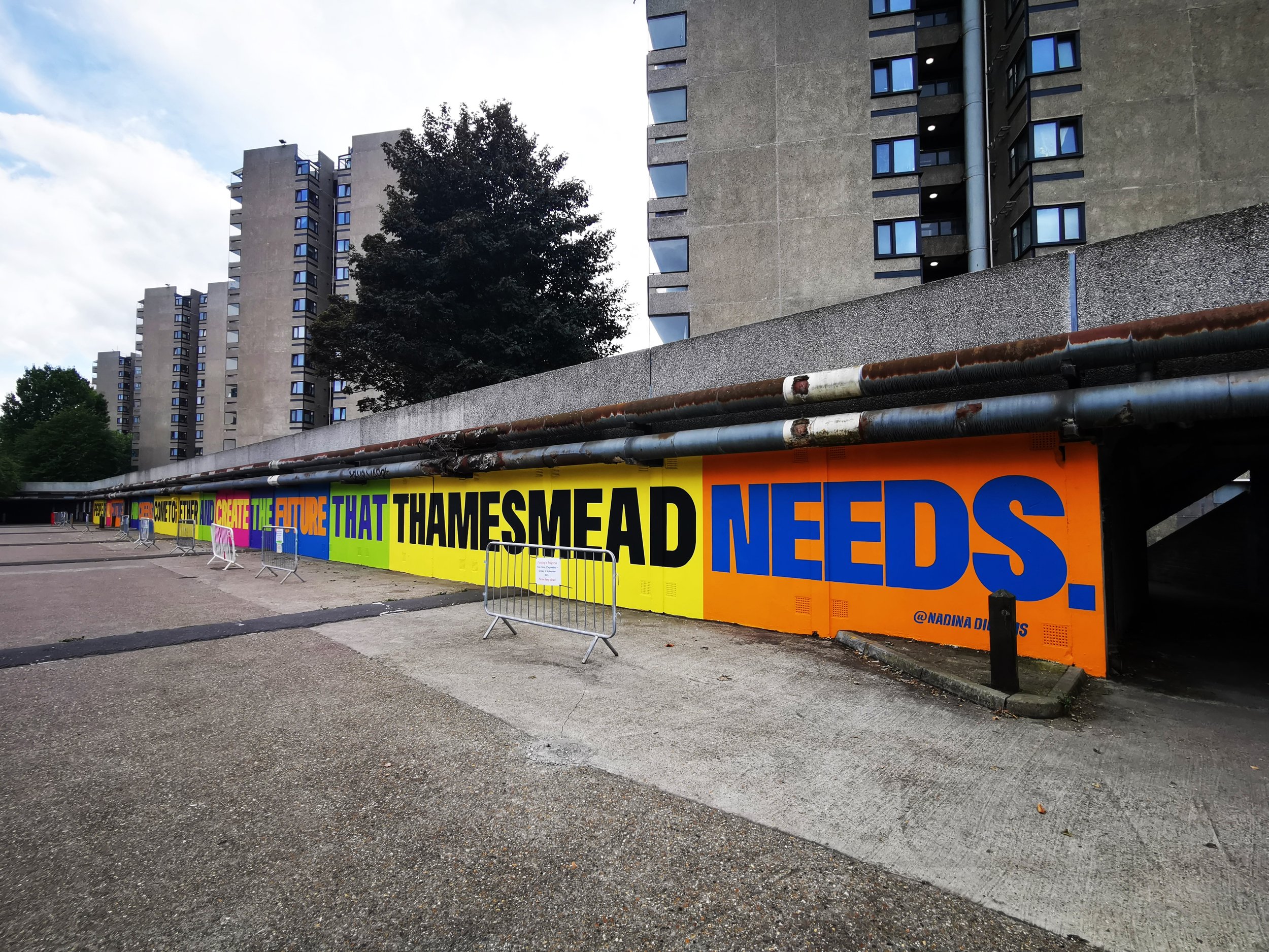  70m long mural commissioned by Peabody for Thamesmead Street Art Trail. The mural reads ‘ People of all cultures and creeds, come together and create the future that Thamesmead needs.’ 