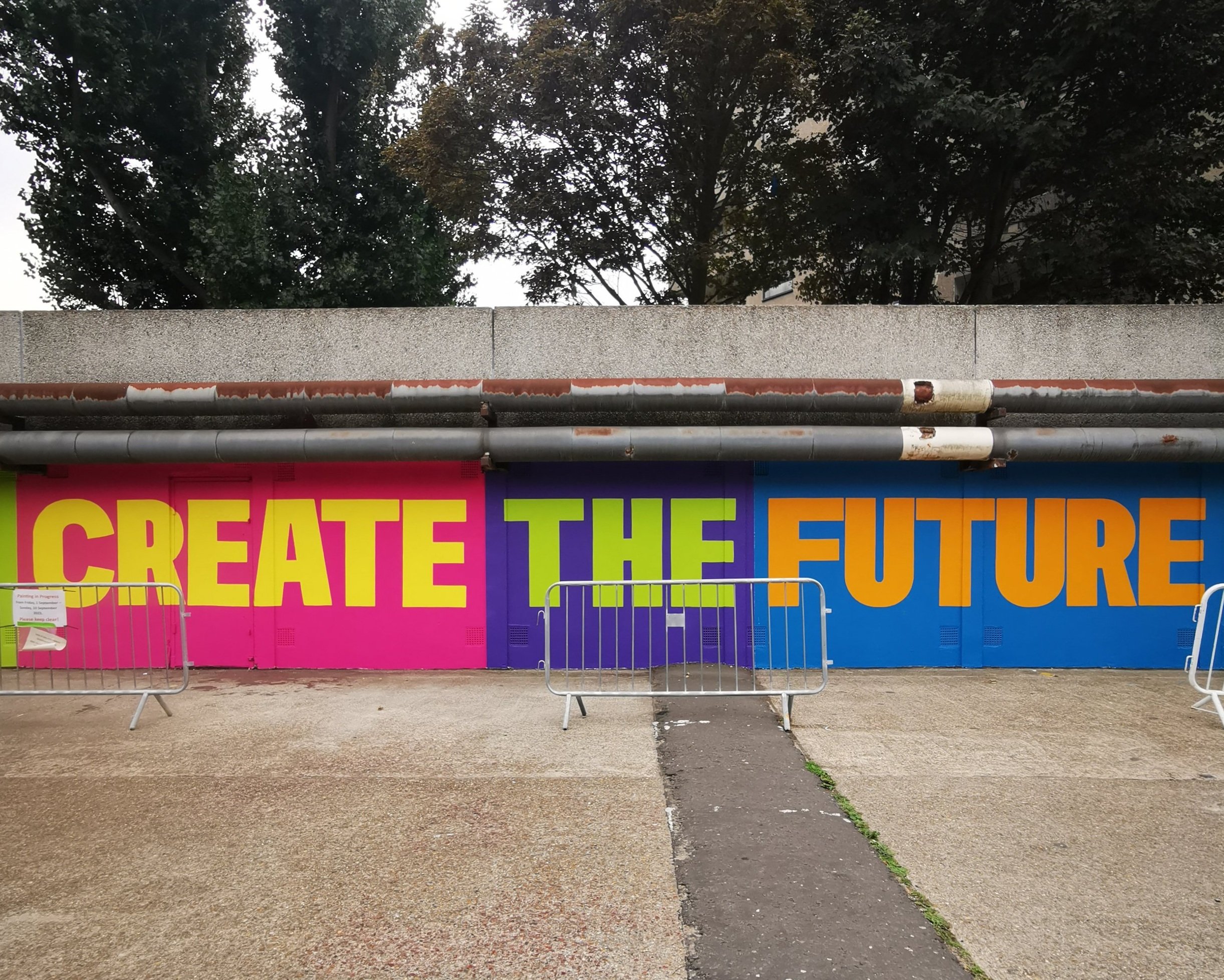  70m long mural commissioned by Peabody for Thamesmead Street Art Trail. The mural reads ‘ People of all cultures and creeds, come together and create the future that Thamesmead needs.’ 