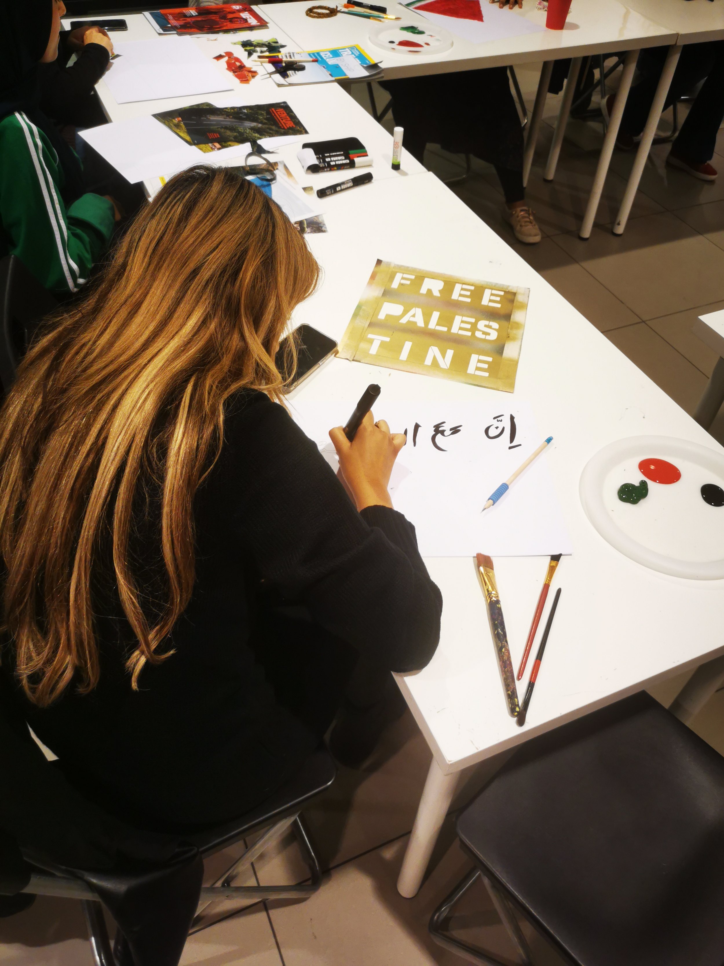  Poster making workshop in support for the freedom of Palestine at the Migration Museum. The workshop was open to all ages and mediums used included drawing, painting and collaging. 