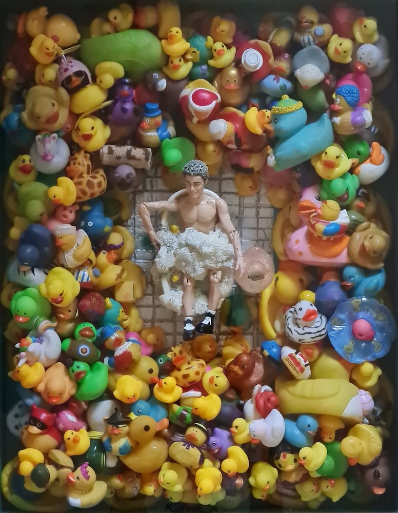 Collection of rubber ducks surrounding a toy figure in a bathtub.