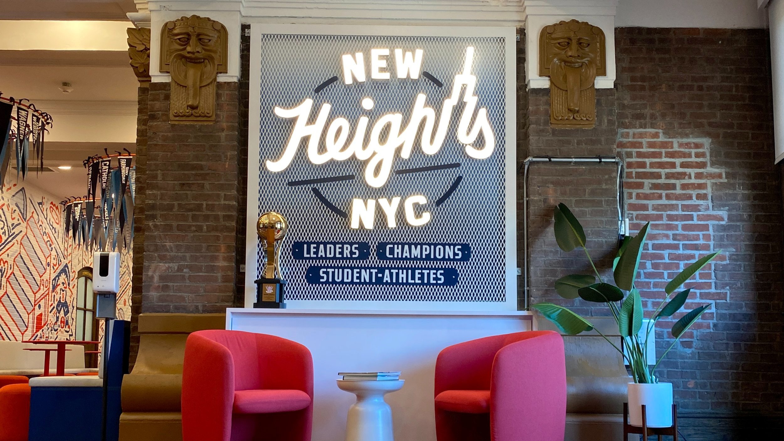  Interior white neon sign reading “New Heights NYC” mounted on a custom fabricated white and blue steel grating display  