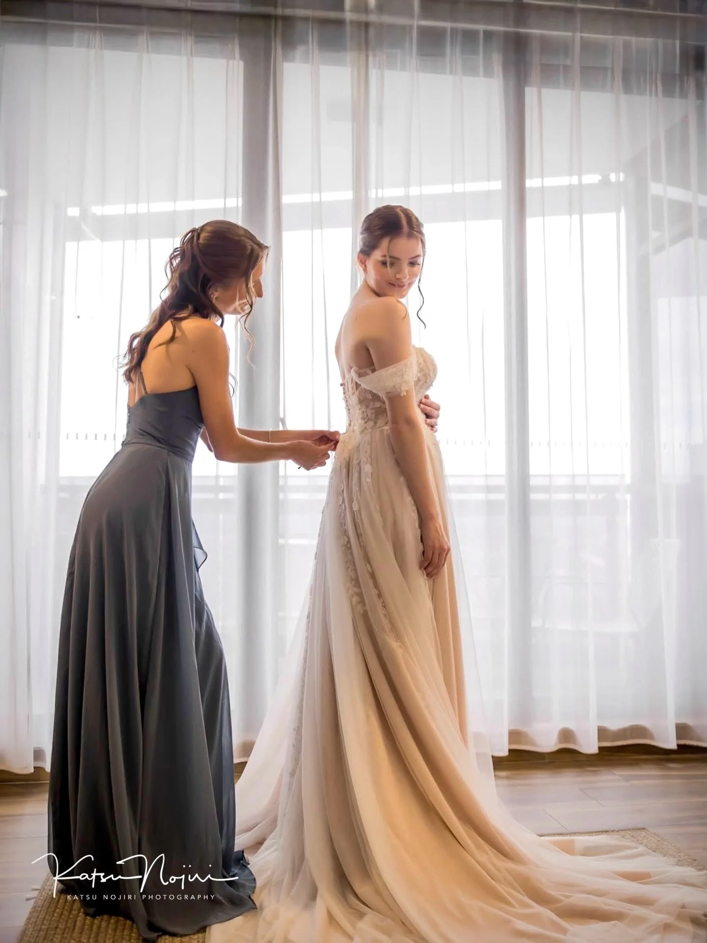 This is the &ldquo;hold still, don&rsquo;t cry, we&rsquo;re definitely on schedule&rdquo; moment.
Buttons being done up, nerves kicking in, and a bridesmaid absolutely earning her title.

Getting-ready photos are where the real stories happen &mdash;