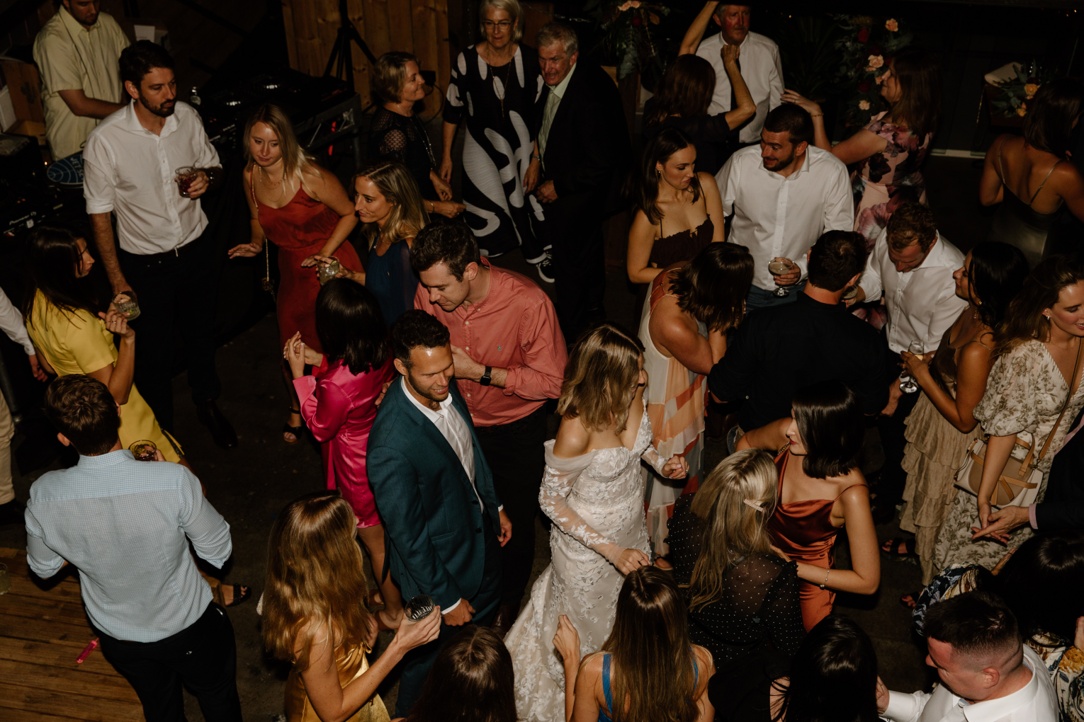 People dancing and socializing at an indoor party or celebration.