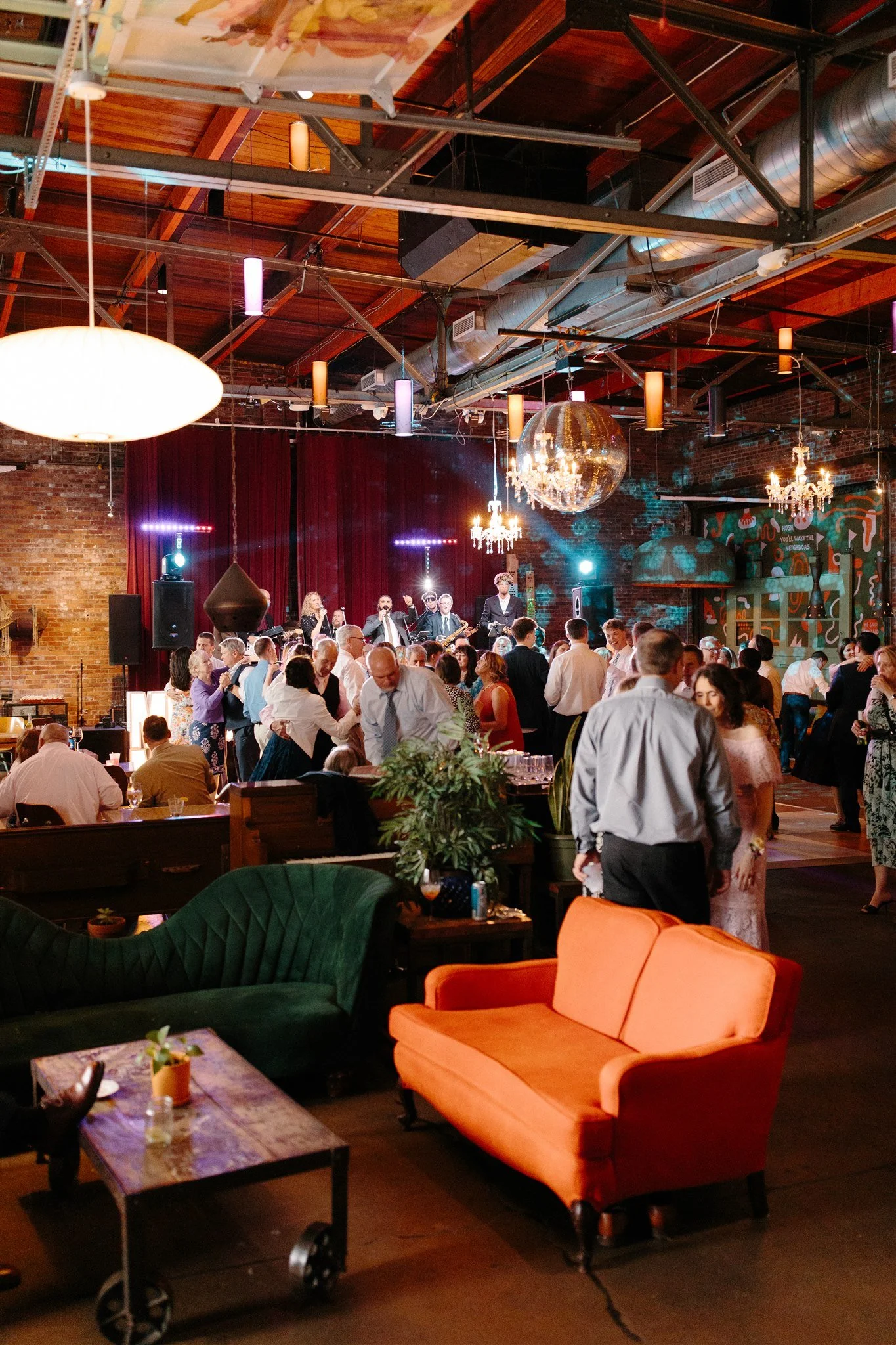 FULL VENUE RENTAL - dance part of reception in the Gastropub dining room. Stage, live band, disco ball, patterned lights and chandeliers..