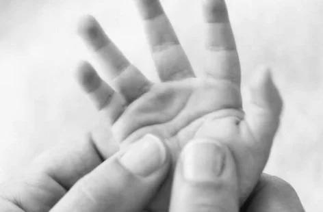 baby-massage-parents-hand-massaging-baby's-hand