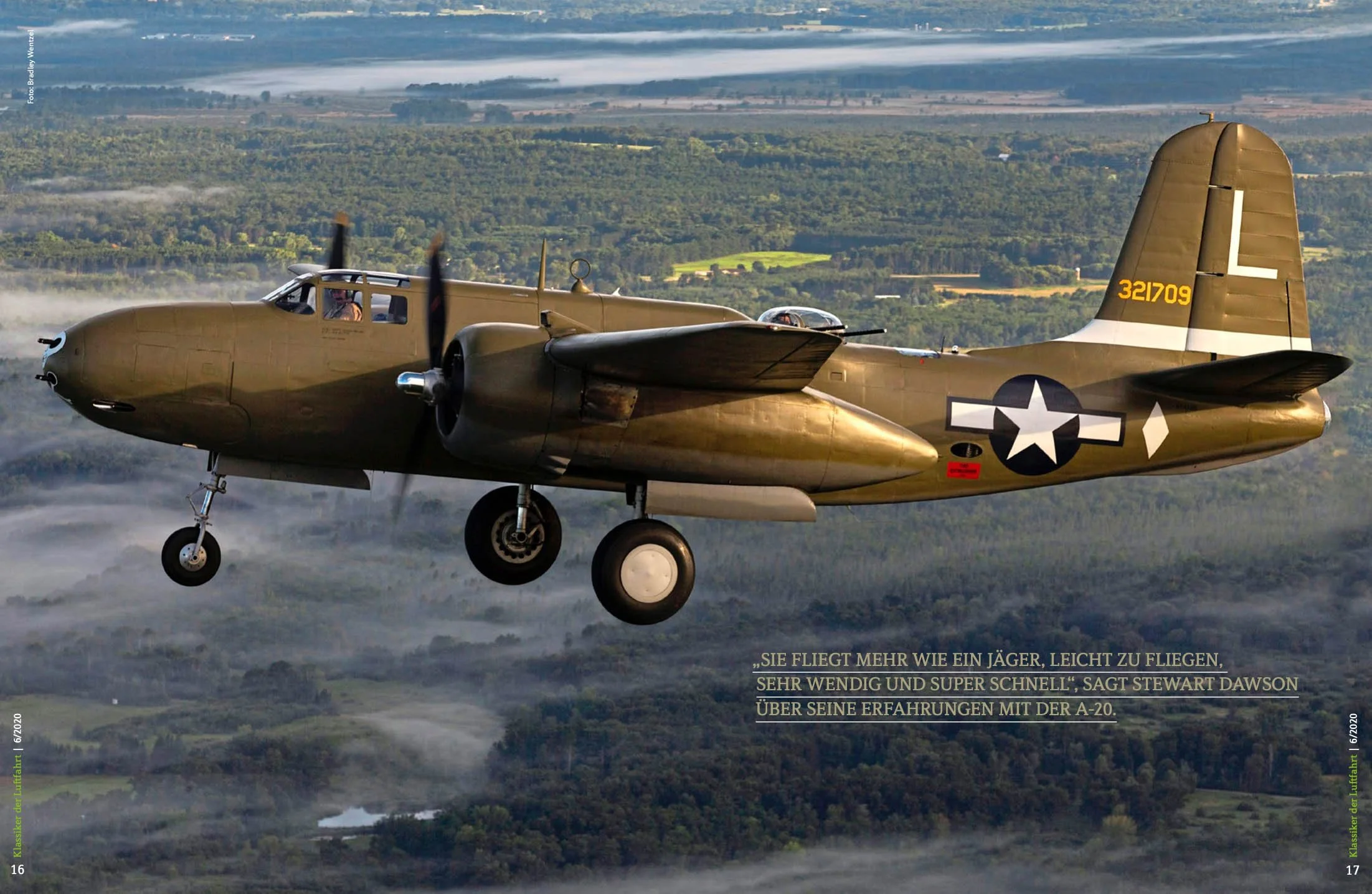 WWII era bomber aircraft in flight over a landscape with forests and fields, featuring military insignia and a camouflage paint scheme.
