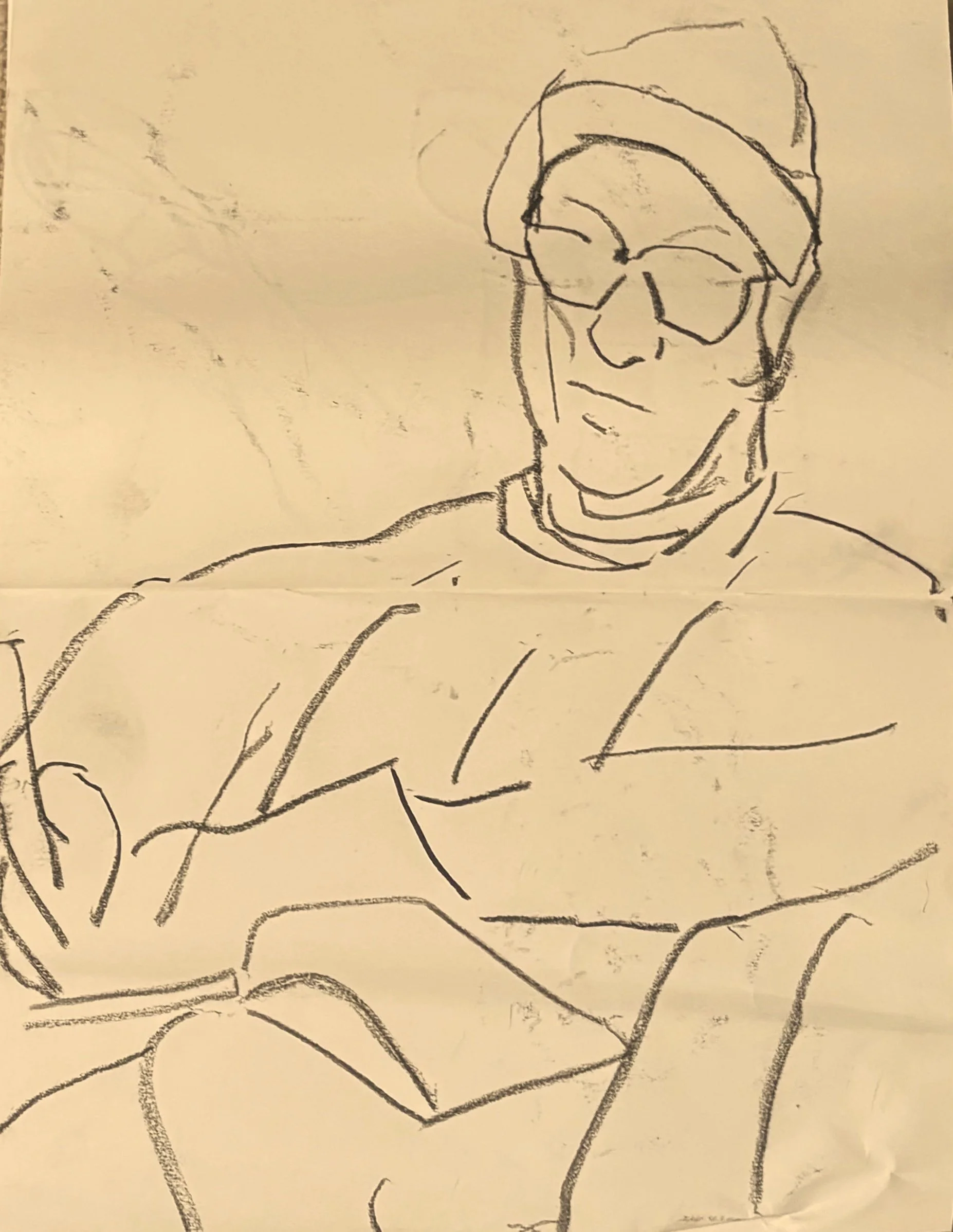 Sketch of a seated man wearing glasses, looking down quietly in a reflective pose.