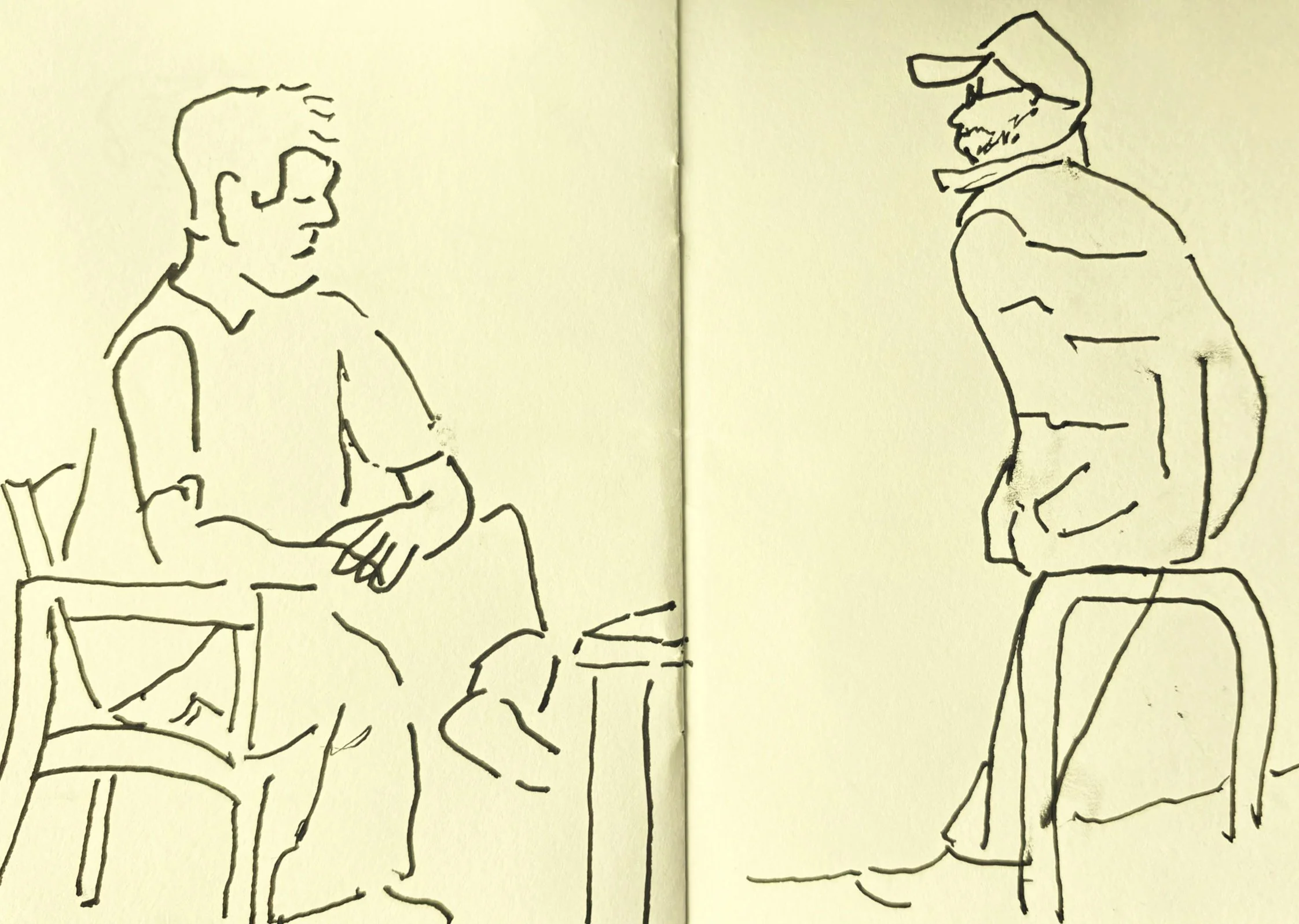 Two men seated quietly, reflective scene suggesting thought and observation