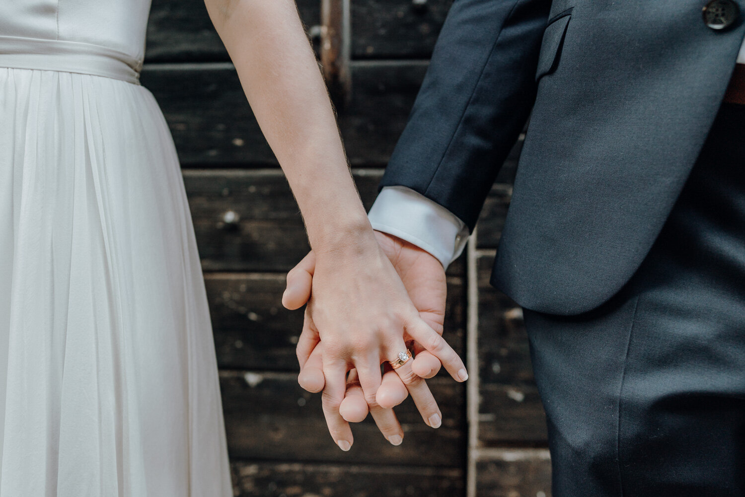 holding hands in front of door wedding 