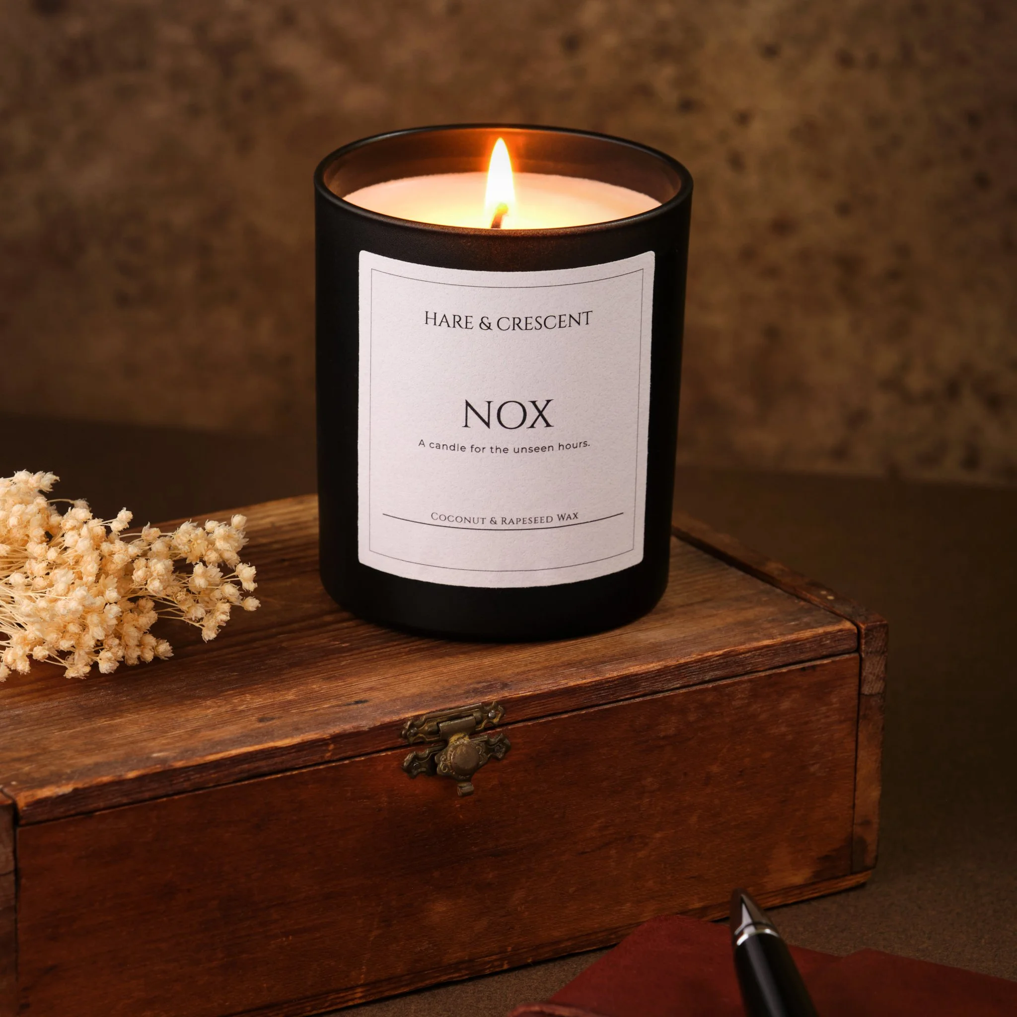 Lifestyle Product Photography - a lit scented candle on a wooden box