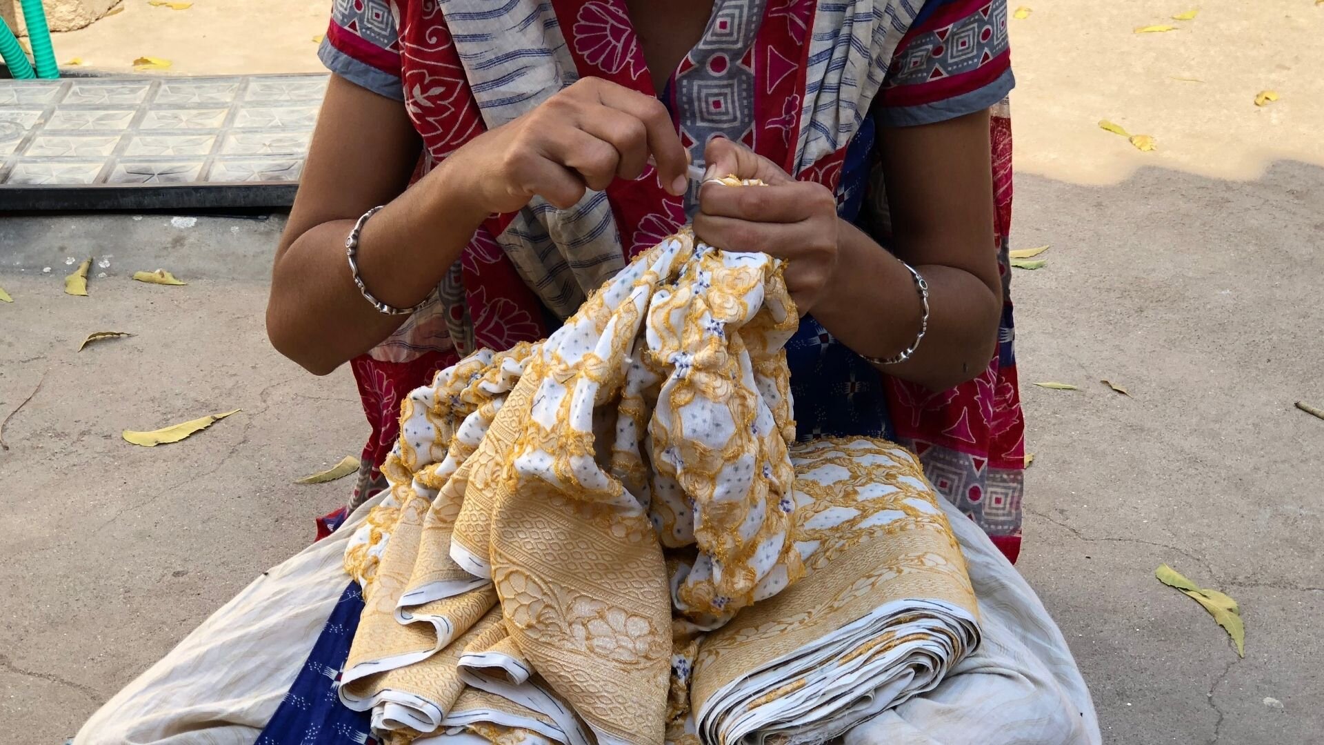 Women tying Bandhani