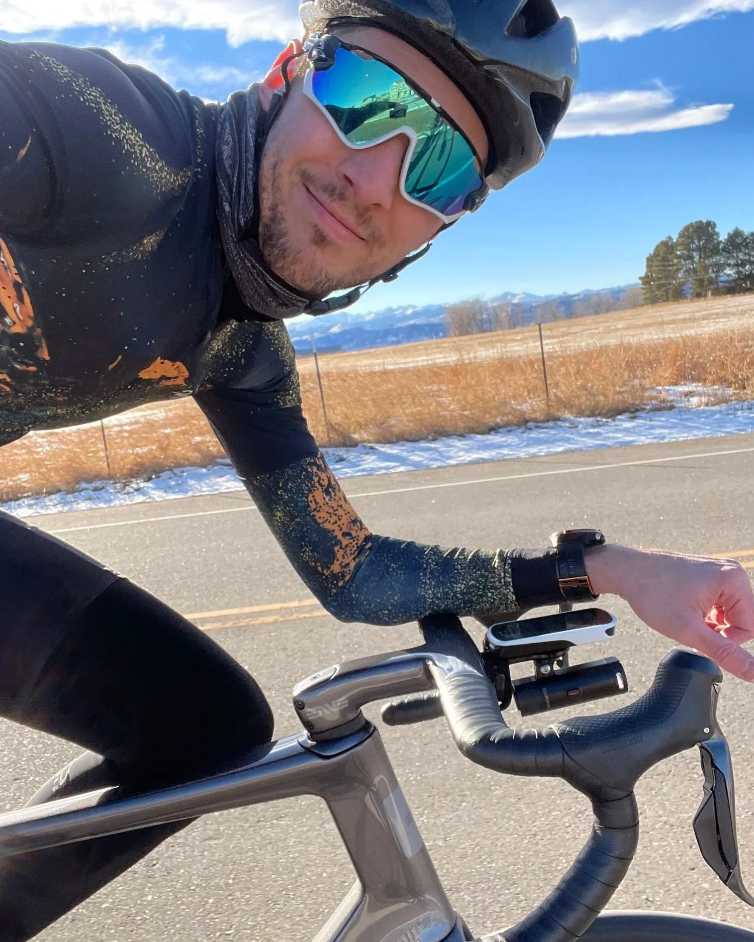 Johann van Zyl riding on a Colorado road in winter, mountains behind