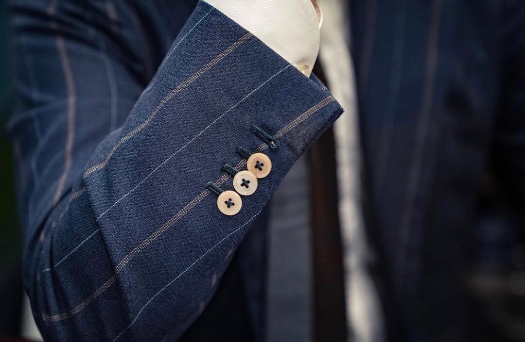 Here's a fun fact about your custom suit. Leaving the last button on your coat sleeve unbutton is known as a surgeon's cuff. 

Surgeon cuffs are considered one of the prominent features of a quality handmade suit. You don&rsquo;t usually find this fe