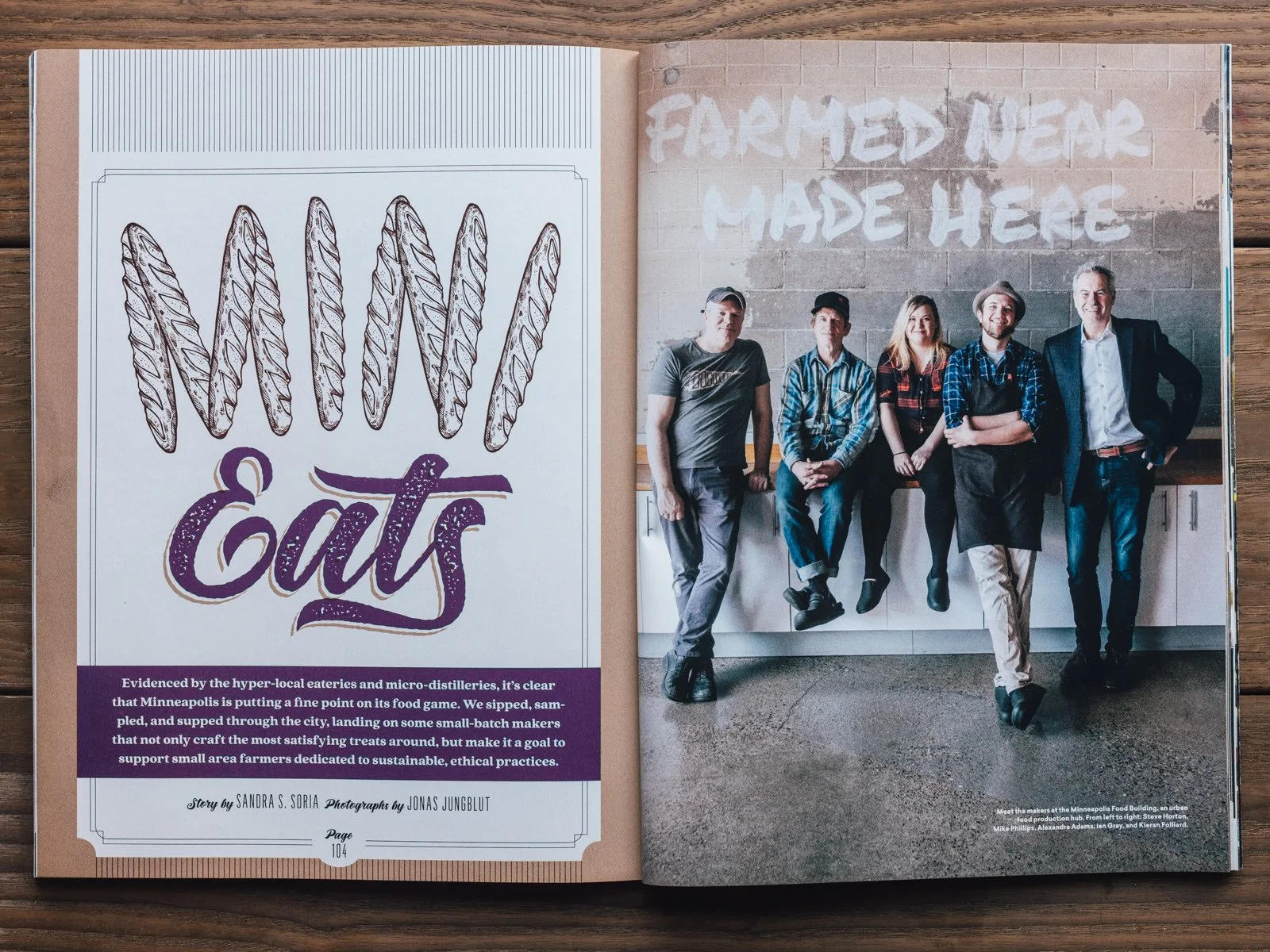 Open magazine showing a page with a drawing of wheat stalks and the word 'Eats' in purple, and a photograph of six people leaning against a food truck wall with 'Farmed Here Made Here' graffiti behind them.