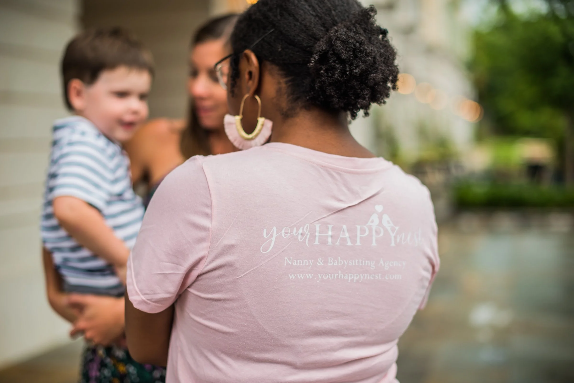 Nanny with pink shirt with Your Happy Nest logo