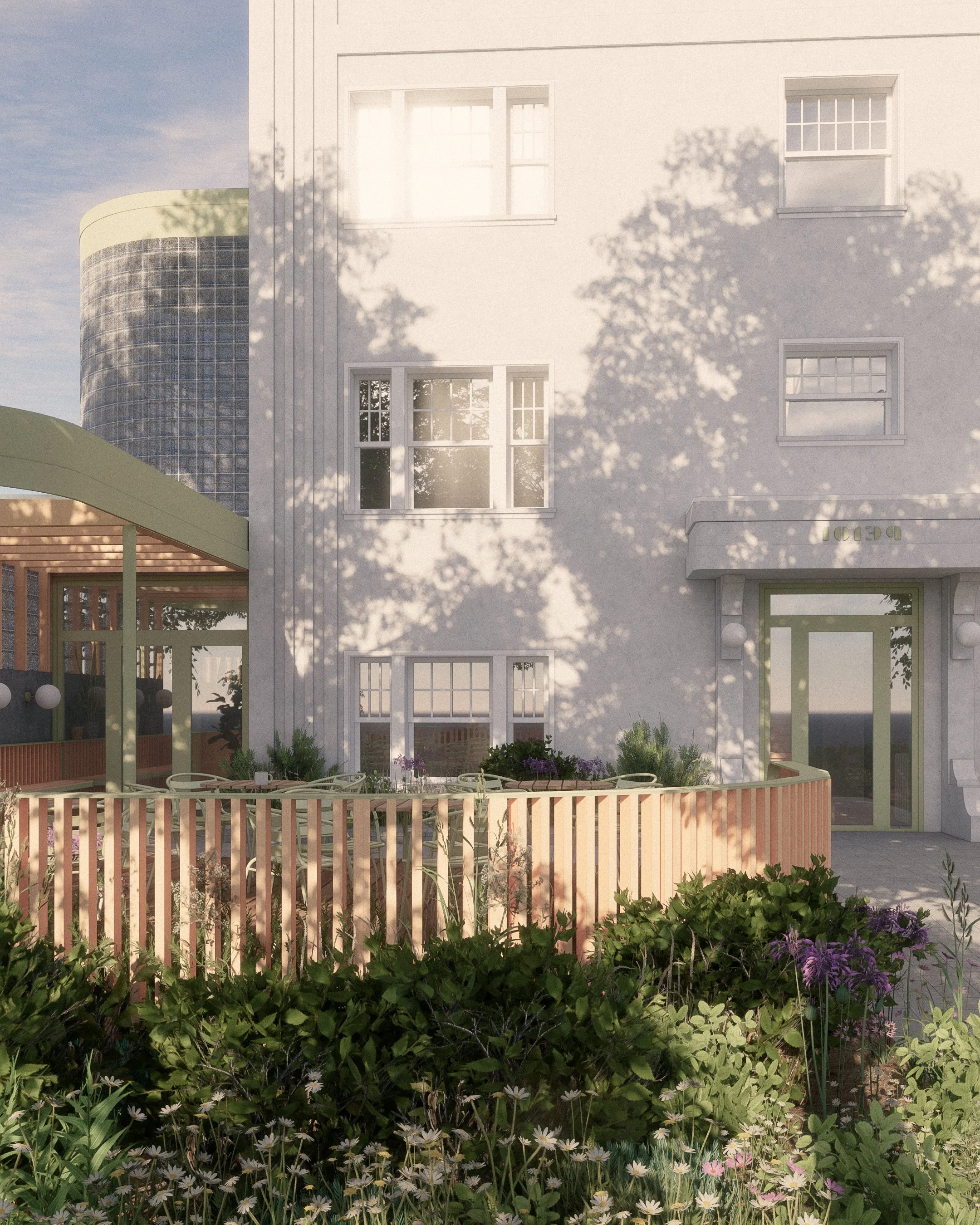 A modern white multi-story building with several windows, surrounded by a garden with flowers, greenery, and a wooden fence, with shadows of trees cast on the facade, and a blue sky in the background.
