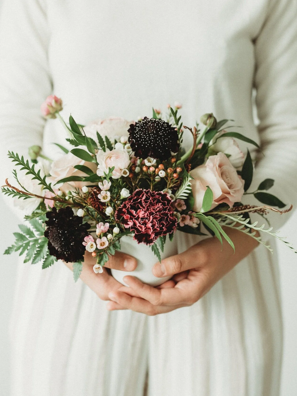 woman holding bouquet of flowers