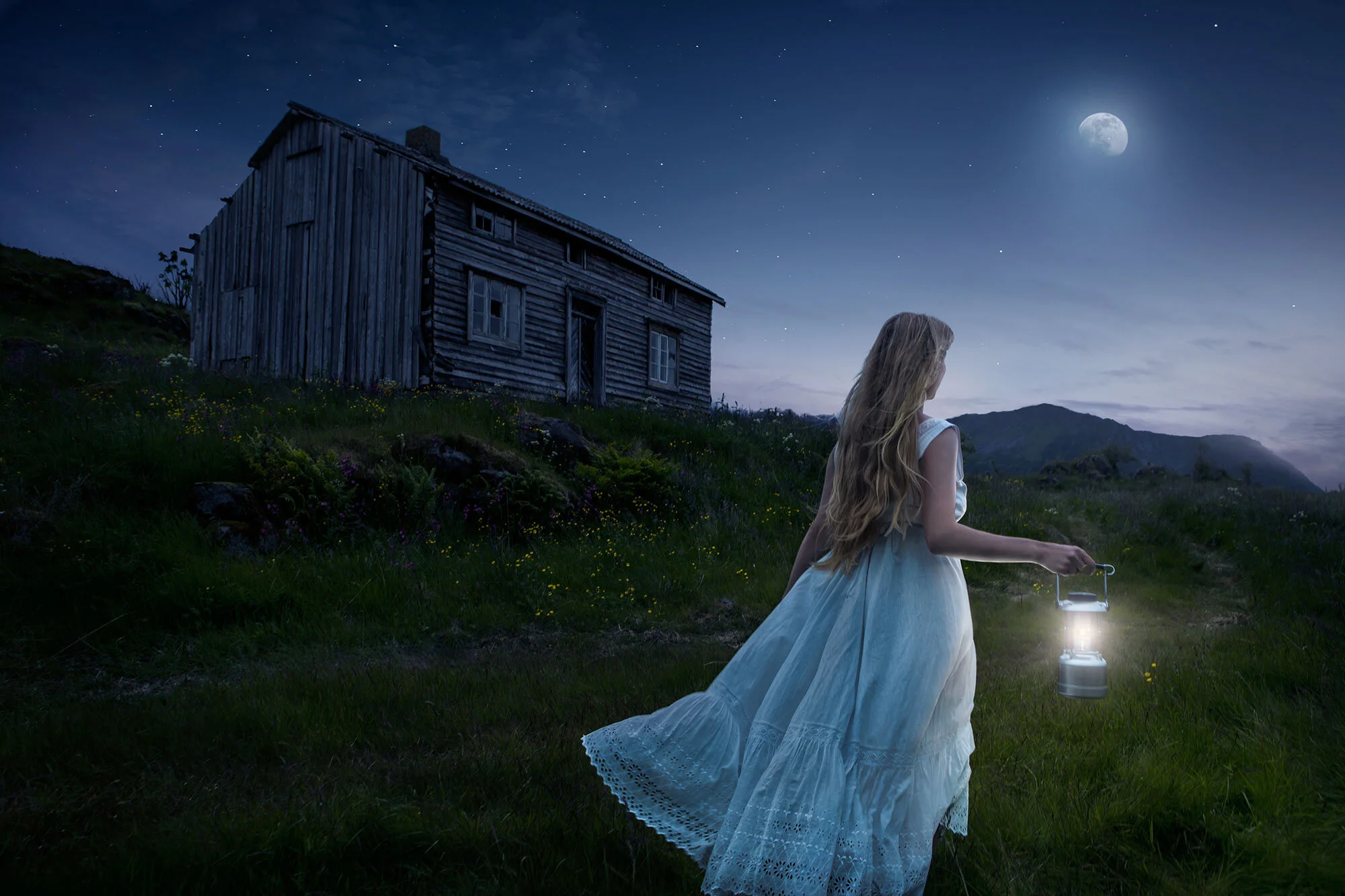 A white woman with long blonde hair, wearing a white vintage dress, holding a lantern walking outdoors at night. There is a full moon, stars, a grassy hill, and an old wooden house in the background in Lofoten, Norway.