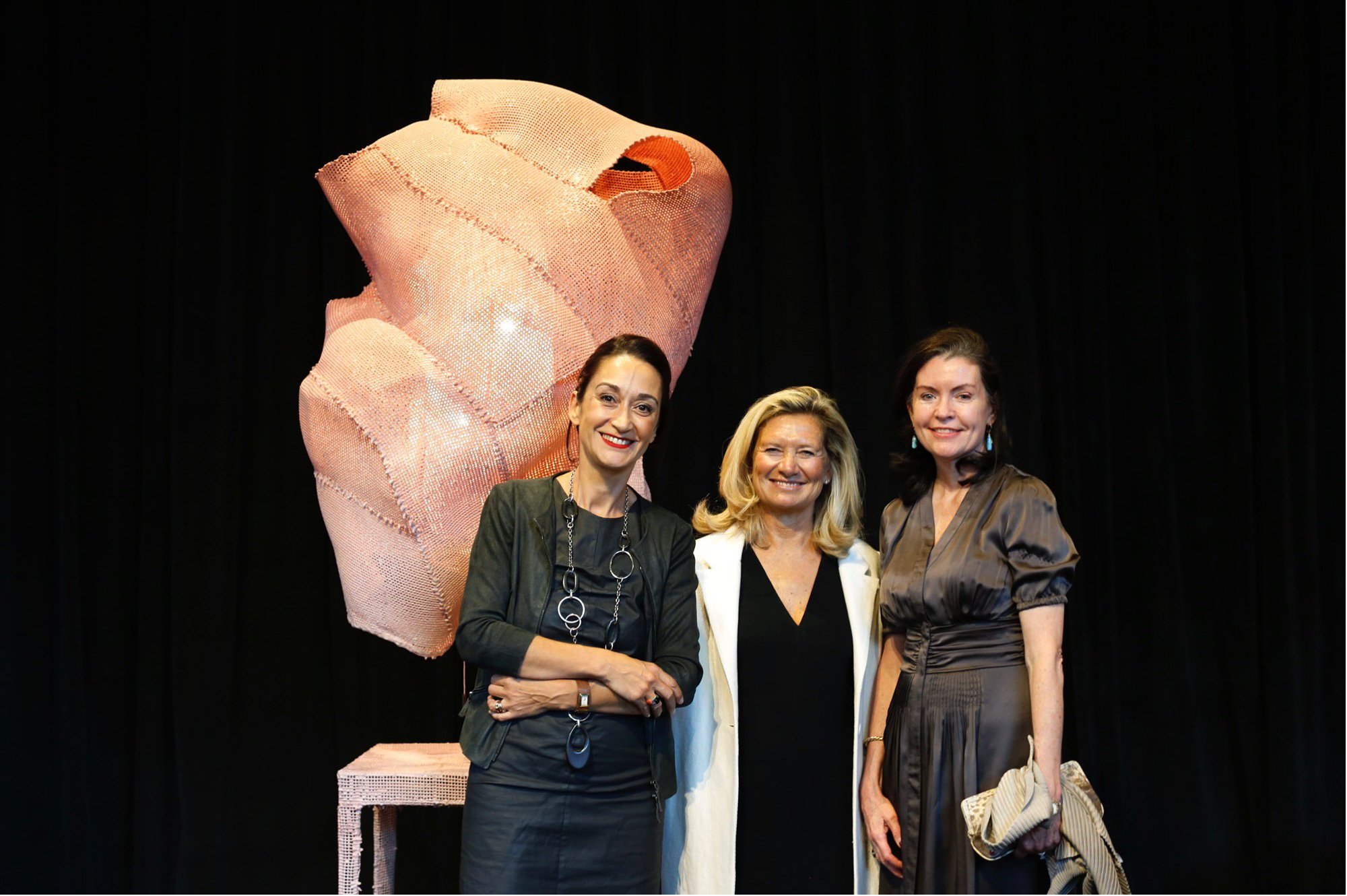 Three women standing besides a piece of art at the Museum of Modern Art in San Francisco, CA.