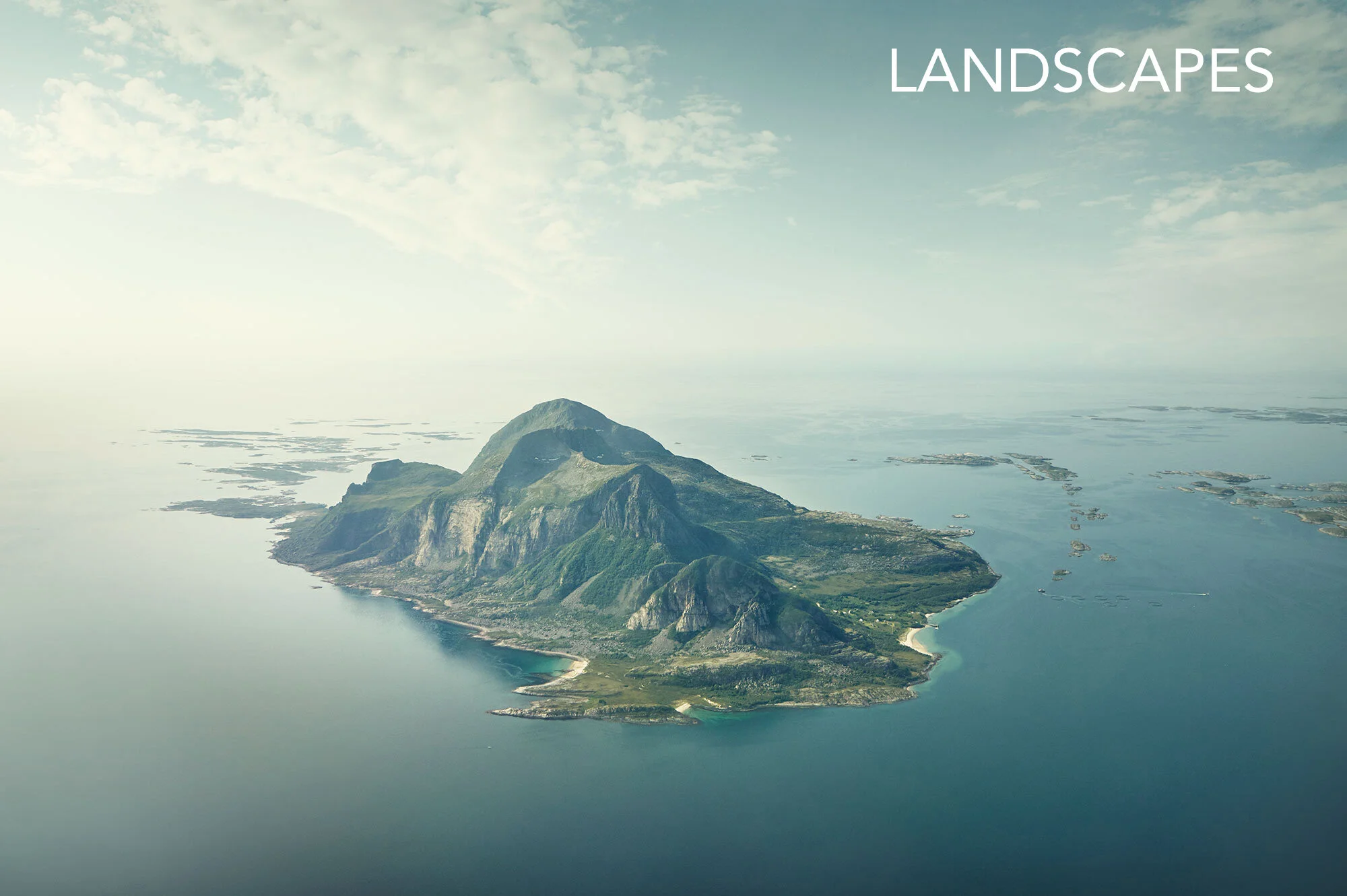 Aerial view of a mountainous island surrounded along the western coastline of Helgeland in Norway, with islands in the distance, under a partly cloudy sky.