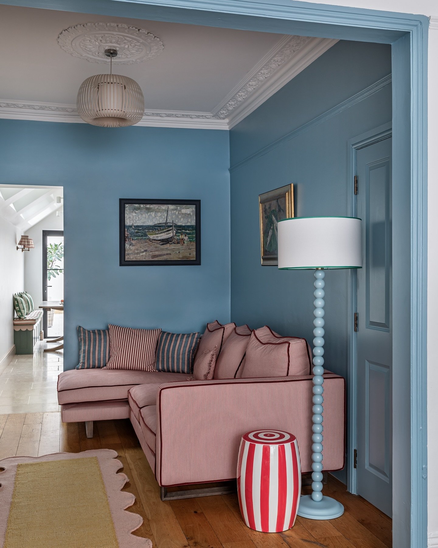 I love this @farrowandball bright blue against the red sofa stripes and being able to see through to @bryonygordon&rsquo;s amazing new kitchen extension. This project included a full kitchen extension and loft conversion and was completed in only 6 m