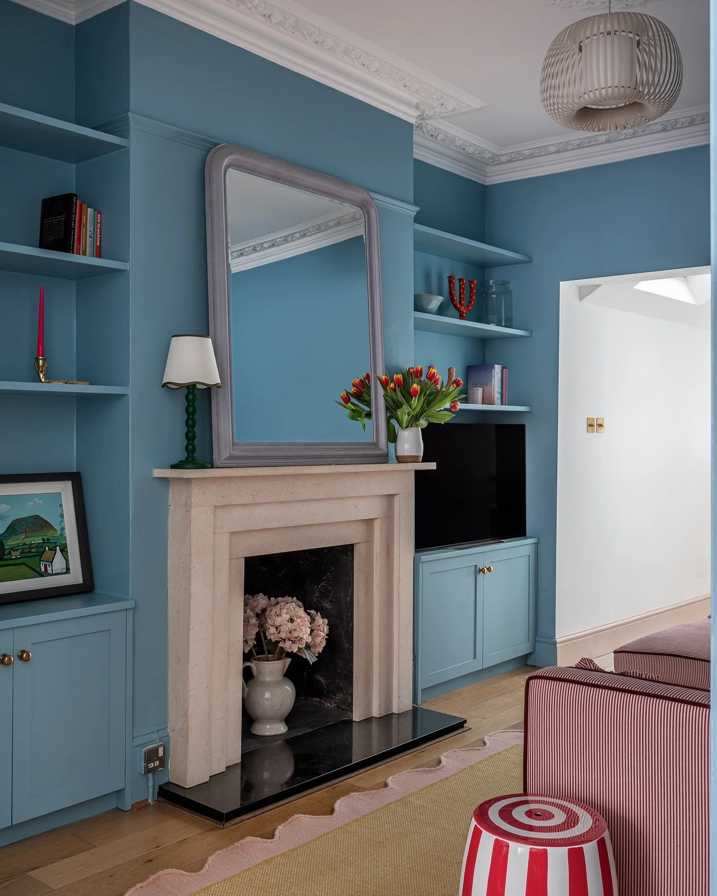 I love this vibrant @farrowandball blue I used in this project that I did for @bryonygordon. Loving the red stripes against the bright blue here and the tulips against the blue walls. I think it&rsquo;s so nice to bring in bright playful colours to m