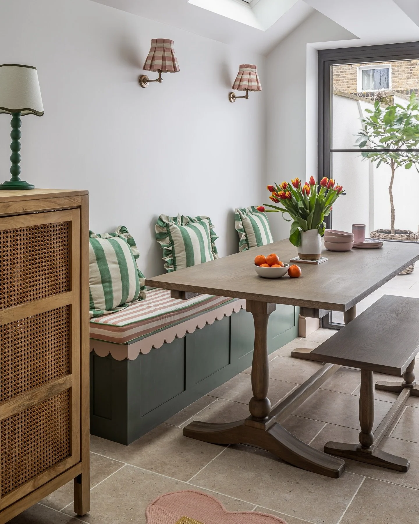 Beautiful green and pink striped&amp;scalloped built in banquet seating in @Bryony Gordon&rsquo;s kitchen in London that I designed. This bench opens up for storage under the striped @alicepalmerco box cushions. So it&rsquo;s not only pretty but prac
