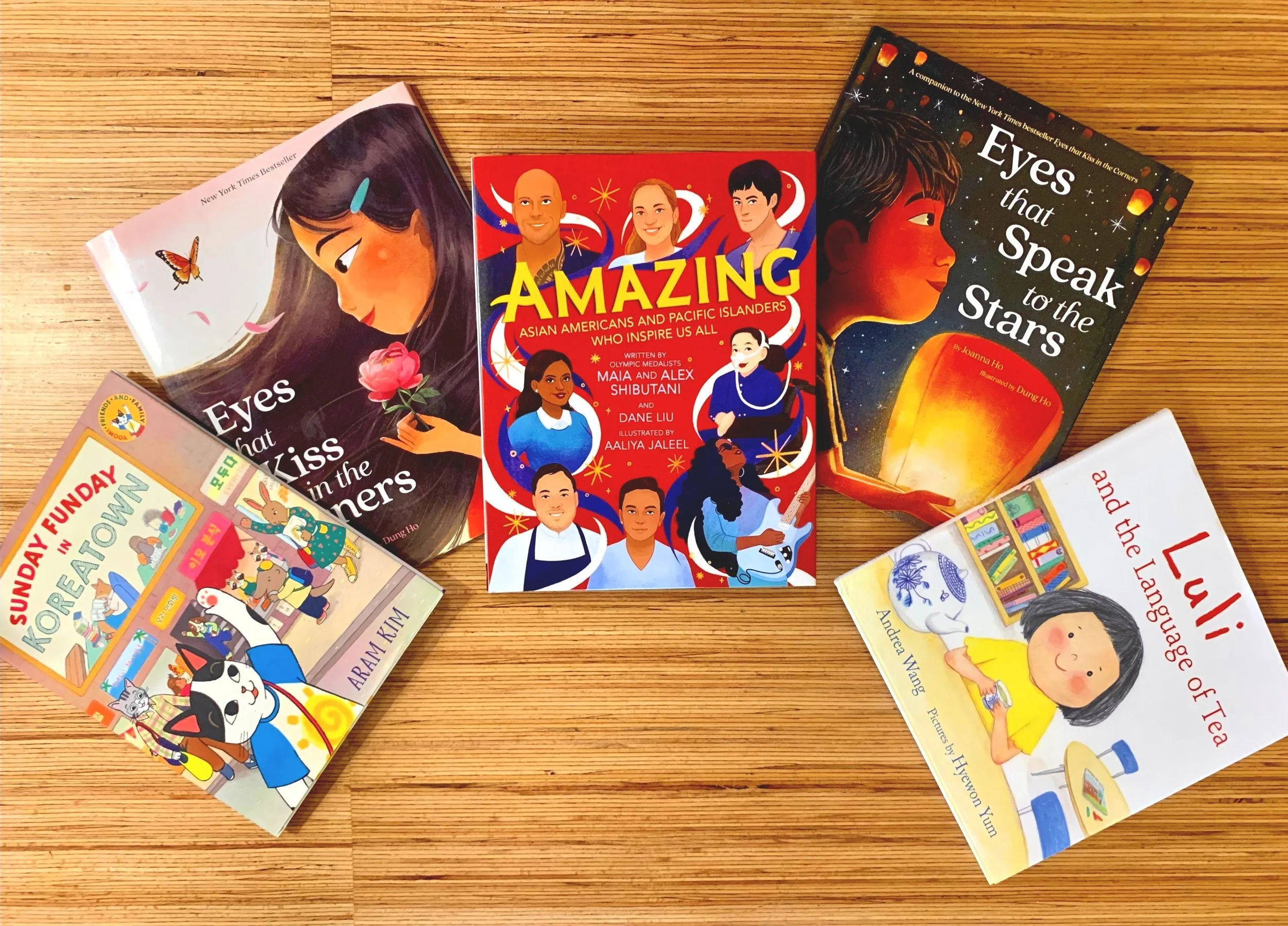 The first five books discussed in this post are displayed together on a wooden countertop.